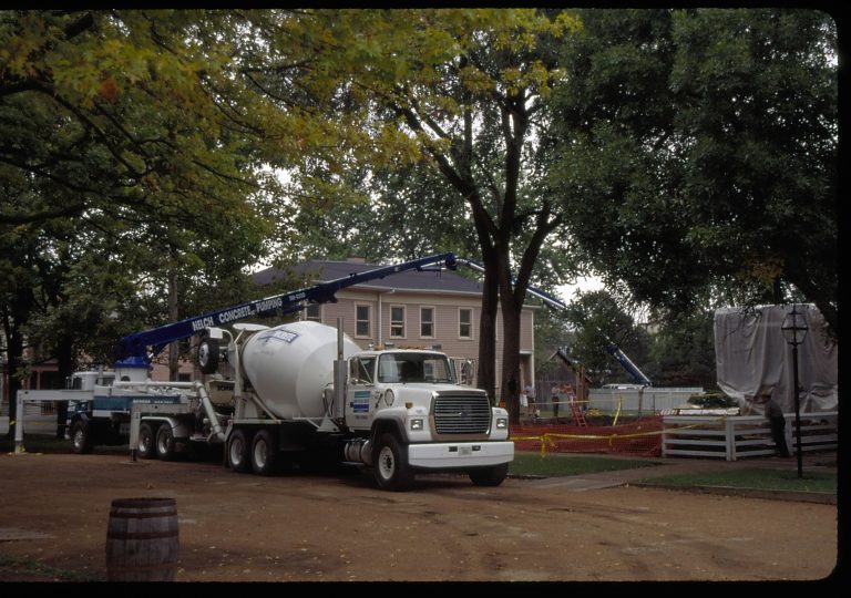 Sprigg House, pouring foundation. East elevation seen if lookin carefully at right, center of slide. North elevation of Miller House seen in background. Photo taken looking south/southwest from 8th/Jackson intersection Lincoln Home NHS- Sprigg House, Roll N3 exp 12 Sprigg House, restoration, foundation