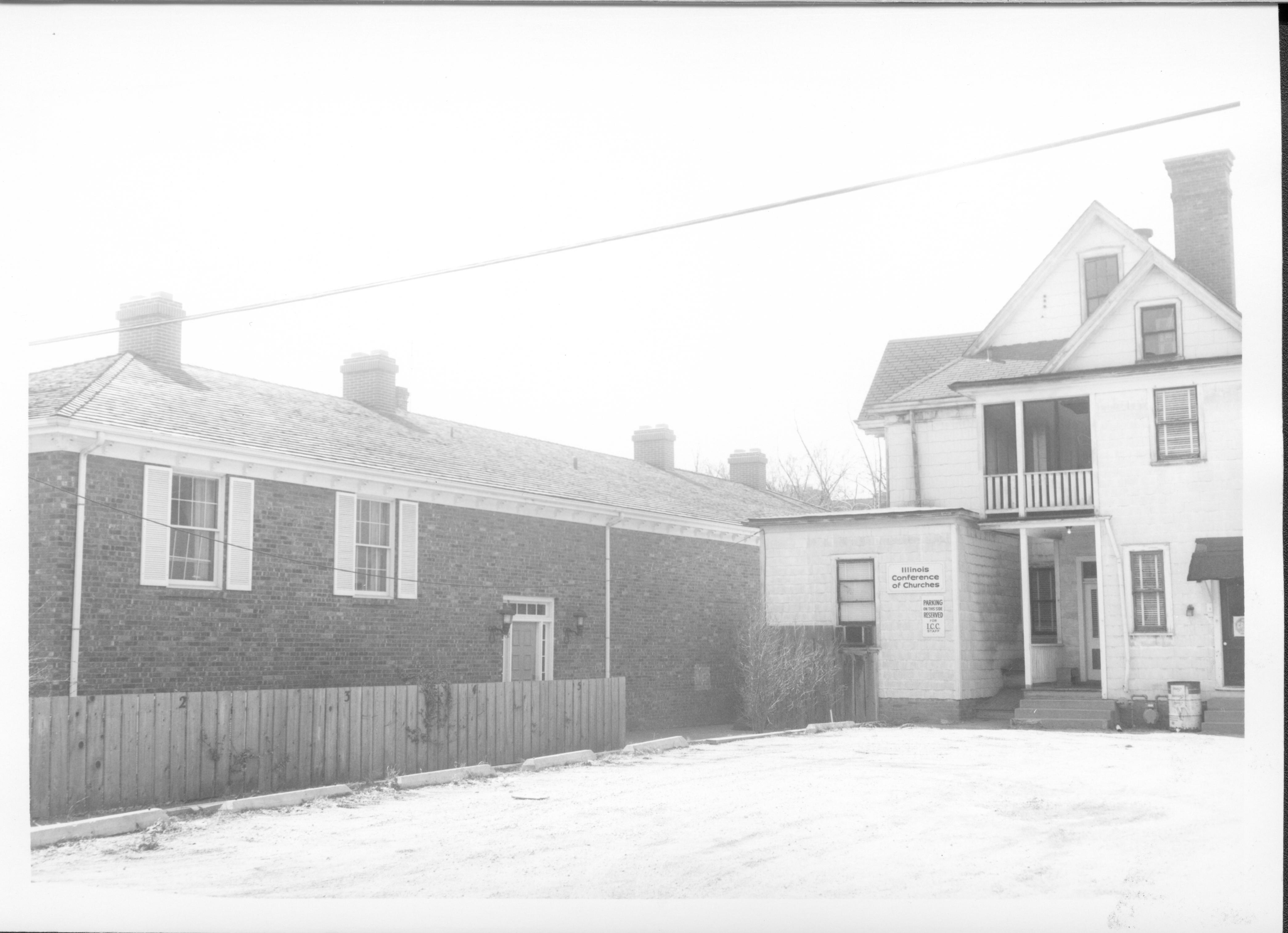 Building on left belonged to Evelyn Grummon and used by Springfield Marine Bank.  Labeled ast the Barrister Building.  House on right owned by Eugene McNally and used by the Illinois Conference of Churches and CROP.  Located on Block 7, Lots 5 & 6 along 7th Street where Visitor Center is now. Looking West/Southwest. Springfield Marine Bank, Grummon, Barrister Building, McNally, Illinois Conference of Churches, CROP, Visitor Center
