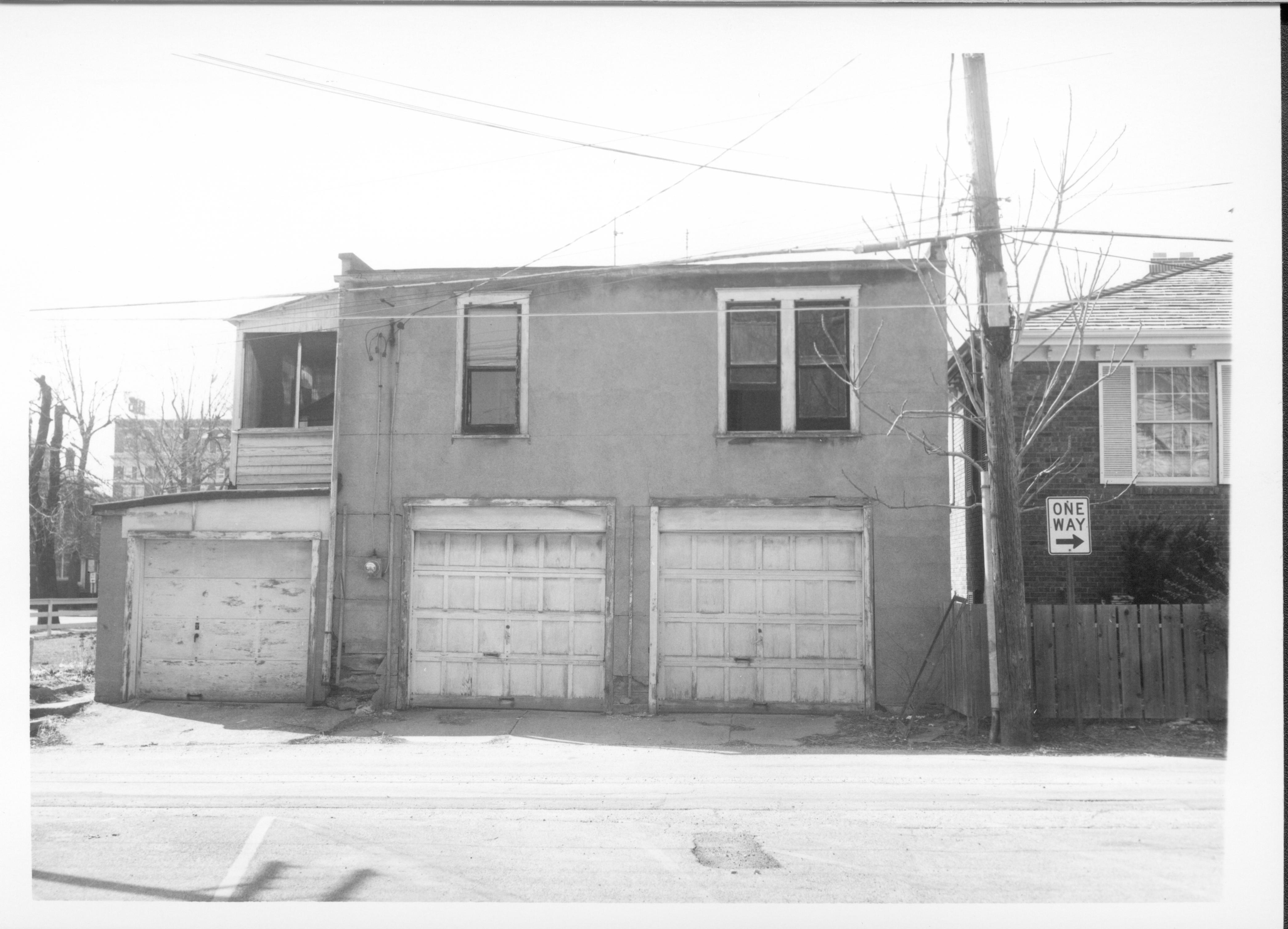 Garage belonging to Eleanor J. Pruett on Block 7, Lot 7 along 7th Street.  Building on right belonged to Evelyn Grummon and used by Springfield Marine Bank as the Barrister Building.  Located where Visitor Center is now. Looking West along alley Pruett, Grummon, Springfield Marine Bank, Barrister Building, Visitor Center