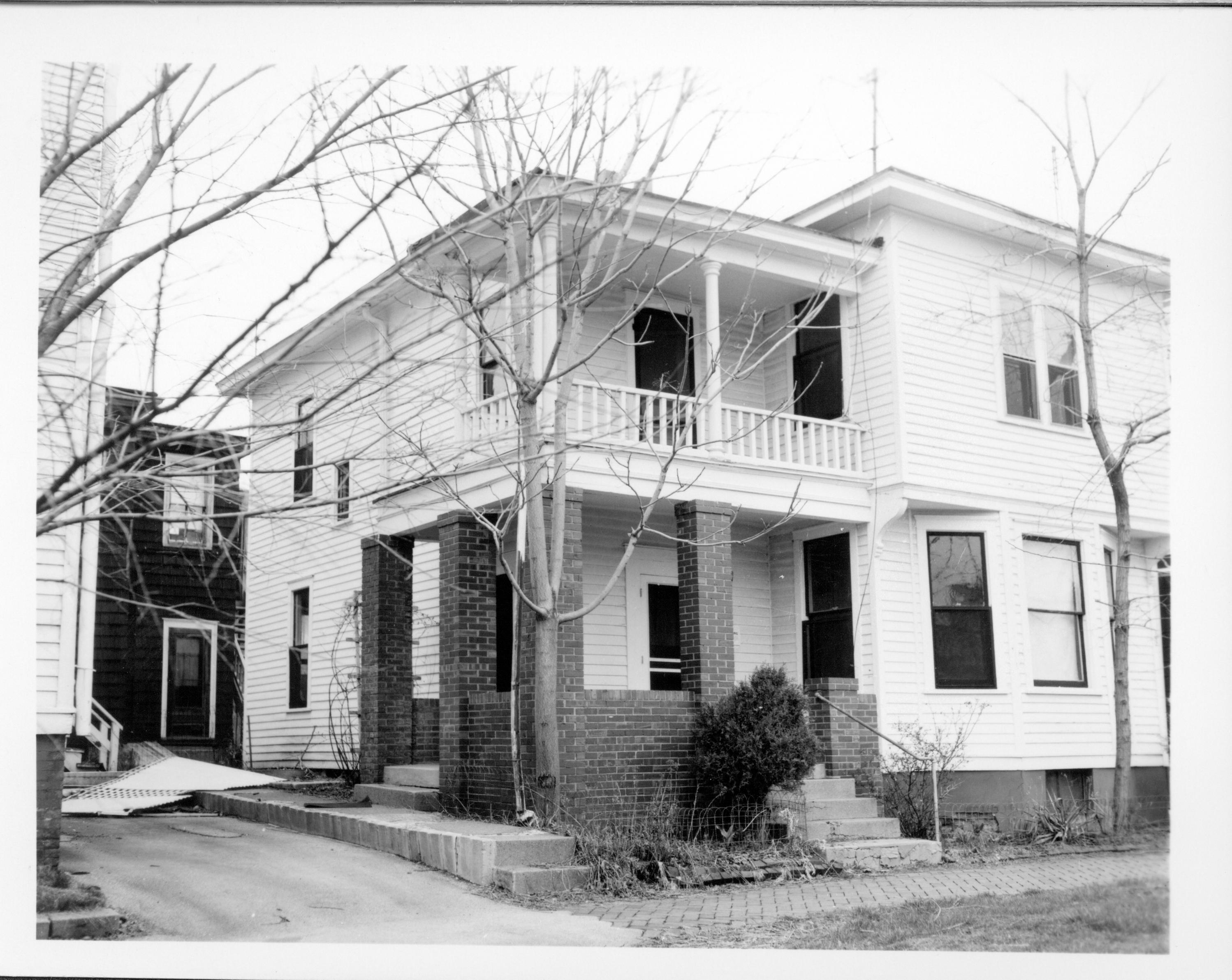 Duplex apartment owned by William Sheeham, Block 7, Lot 8 along Jackson Street.  Area is Visitor Center now. House on left owned by William Hermes, Building in background owned by Eleanor Pruett Looking Northeast from Jackson Street Sheeham, Hermes, Pruett, Jackson Street, Visitor Center