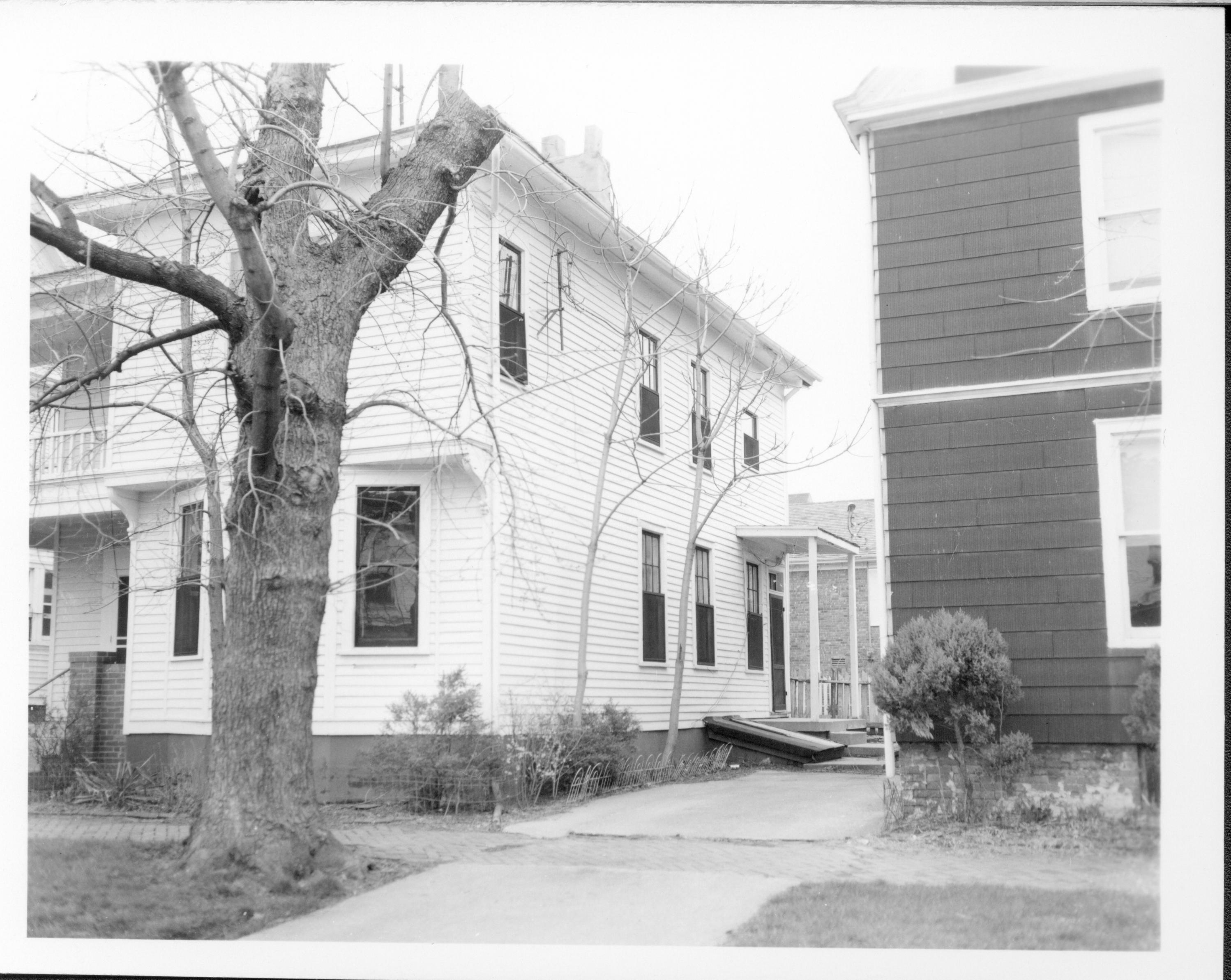 Duplex apartment owned by William Sheeham, Block 7, Lot 8 along Jackson Street.  House on right owned by William Hermes. Area is now Visitor Center.  Looking Northwest from Jackson Street. Sheeham, Hermes, Jackson Street, Visitor Center