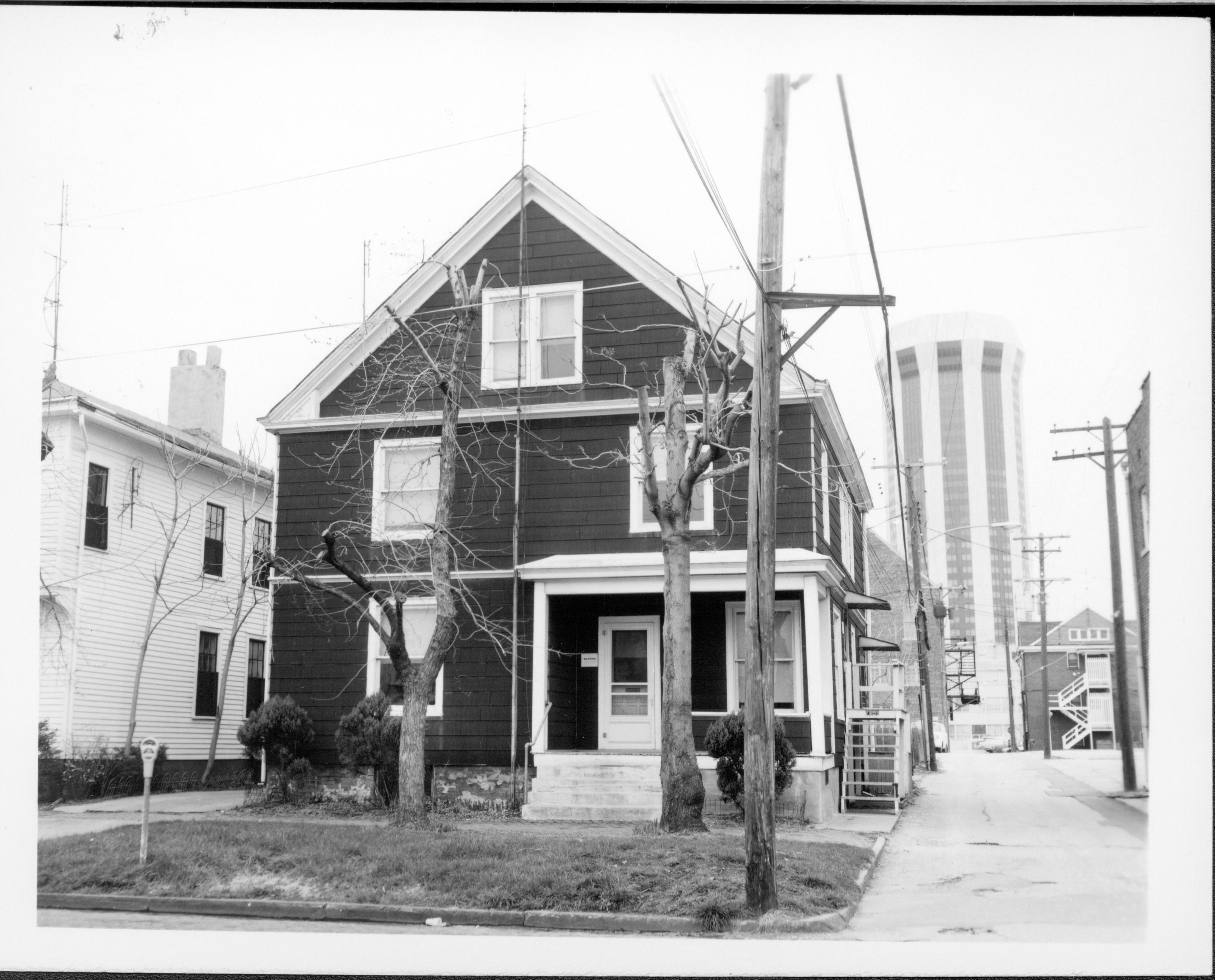 House owned by William Hermes in use as apartments, Block 7, Lot 8, along Jackson Street near alley.  House owned by William Sheeham on left.  Hilton Hotel tower seen in background on right. Back of house w/fire escapes owned by Mills White.  Area is now Visitor Center  Looking North along Jackson Street near alley Hermes, Sheeham, Hilton Hotel, White, Jackson Street, Visitor Center
