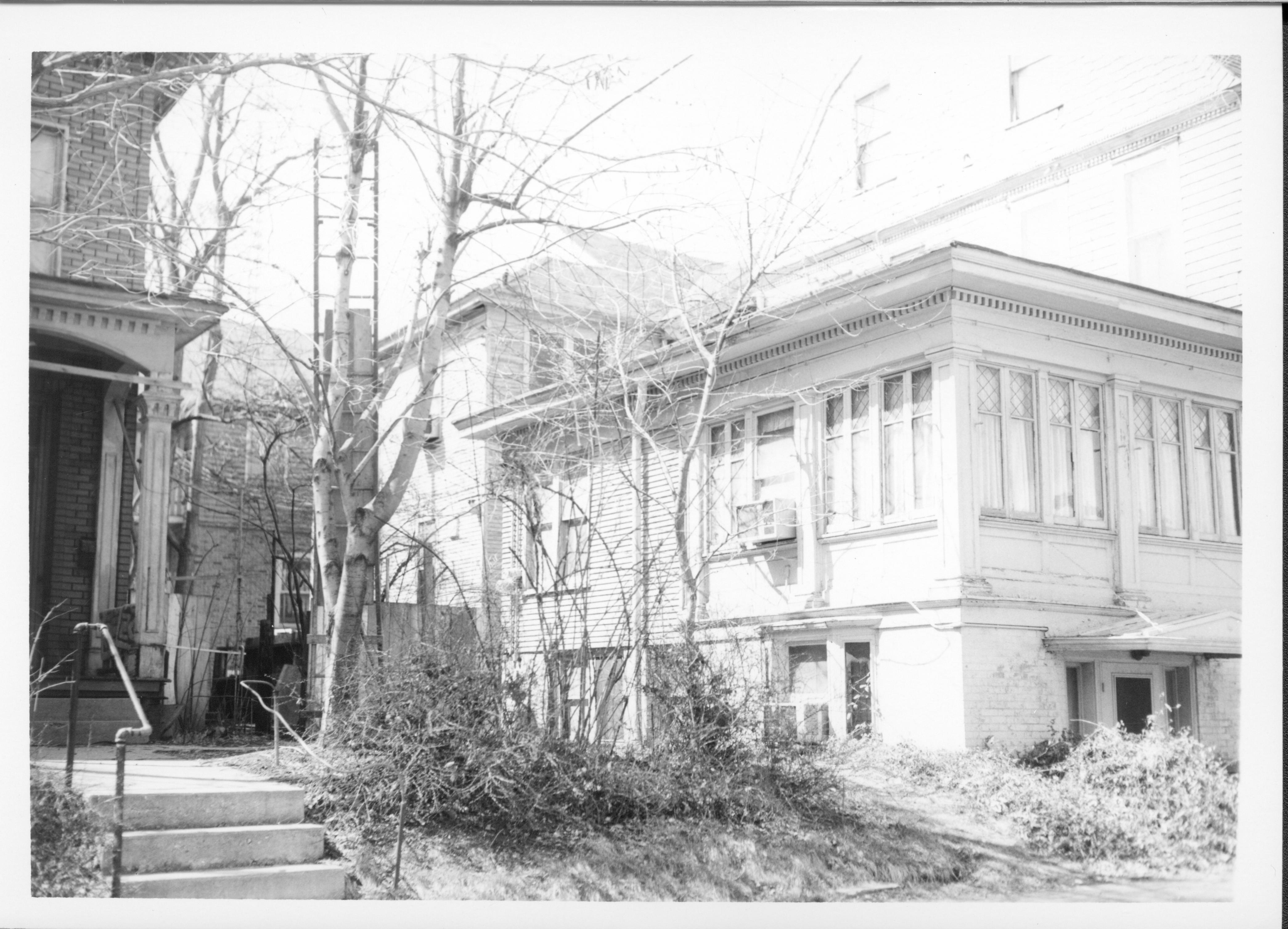 House owned by Dorothea Lennox used for apartments, Block 7, Lots 16 & 15, along Capitol Ave. Second house owned by Dorothea Lennox in background center. House owned by Bernard Bowman left of center. Beedle House at far left. Area is now empty Walters lot. Looking Northwest from 8th Street Lennox, Bowman, Beedle, Capitol Ave. 8th Street