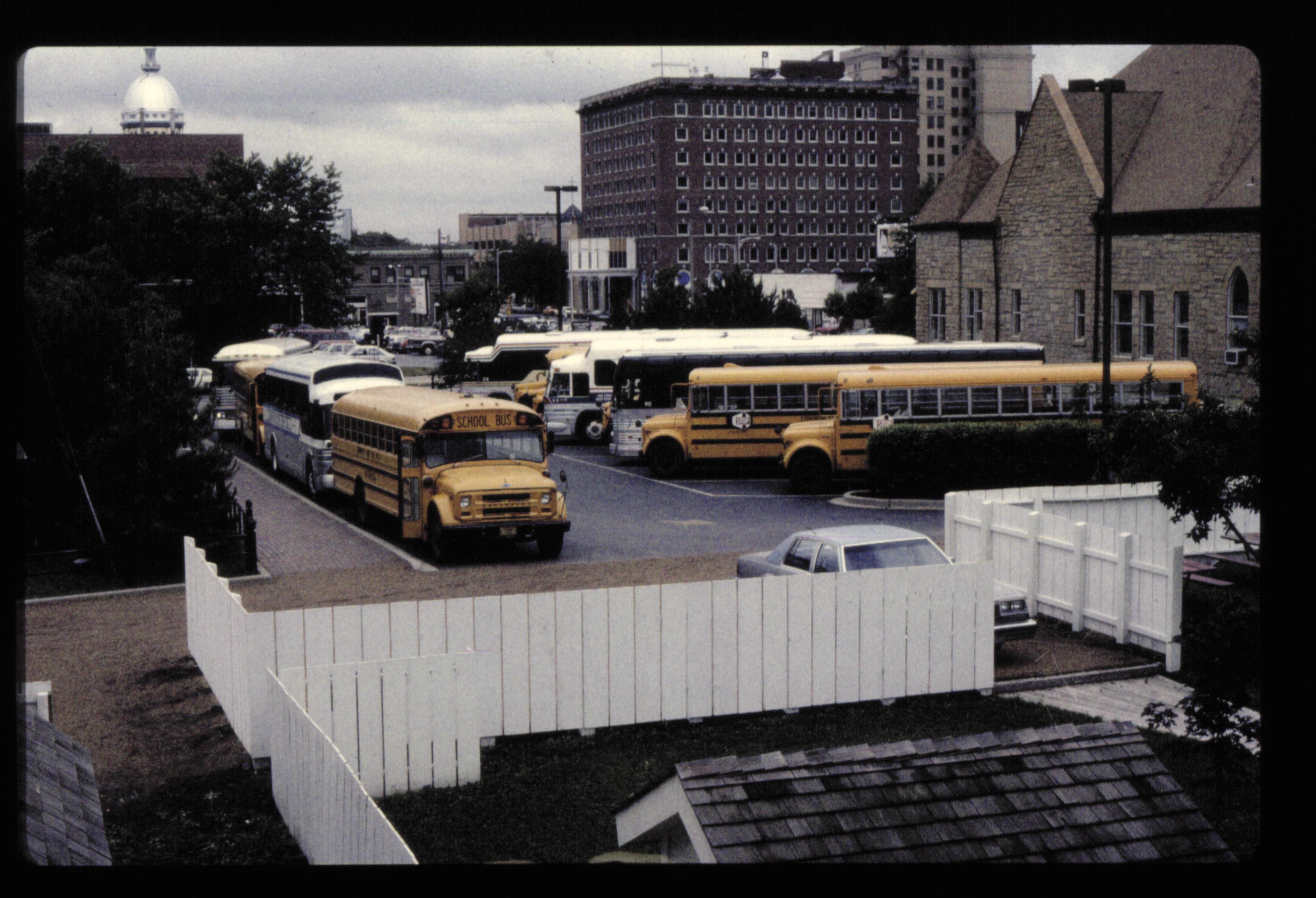 Parking lots - bus parking lot, Grace Lutheran Churd on right, former Lelan Hotel in background center, Capitol Dome on left looking Northwest buses, parking lot, Grace Lutheran Church, State Capitol