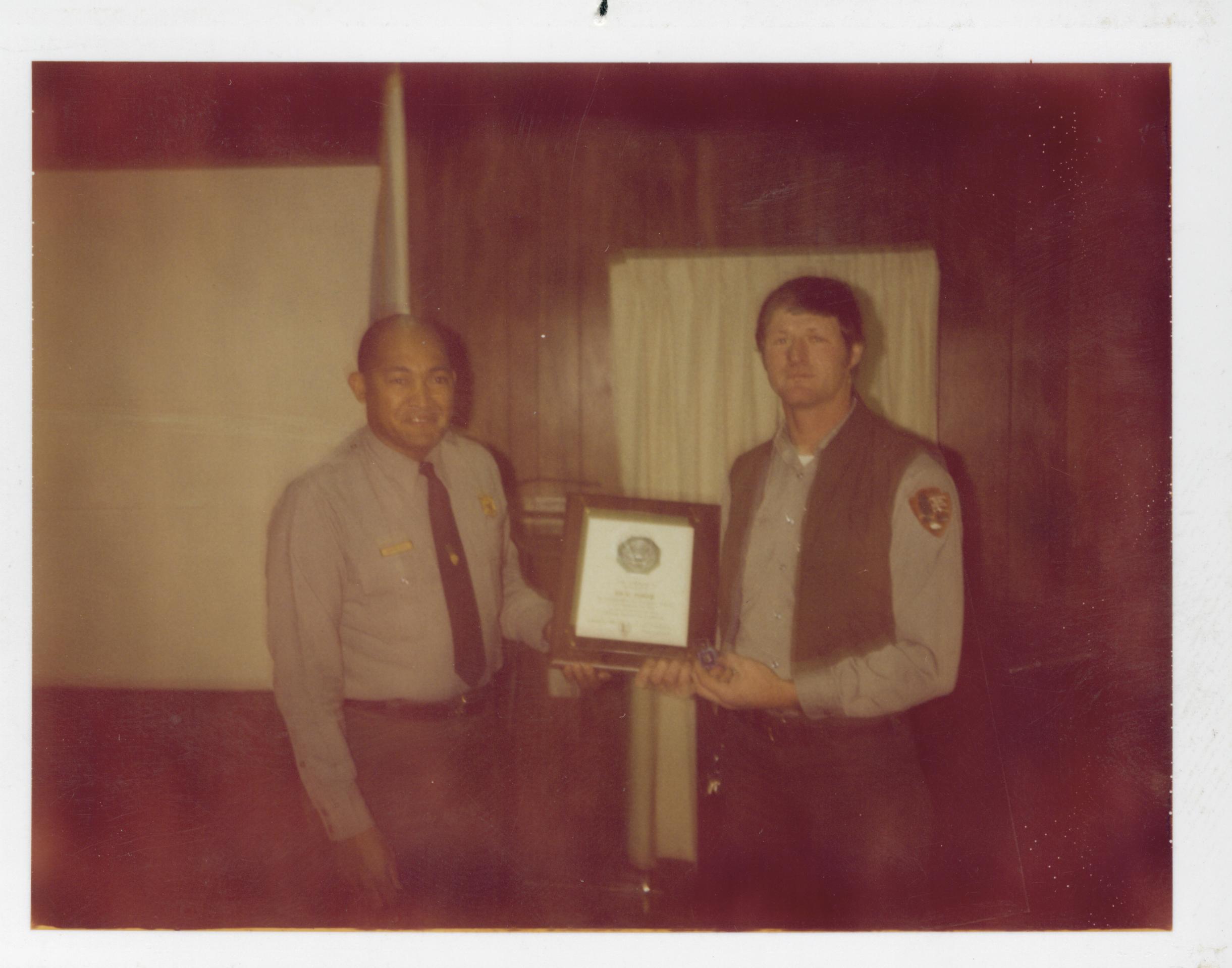 Award ceremony for staff in Conference Center.  Supt. Gentry Davis gives anniversary award to Maint. Worker Vee Pollack looking West on second floor awards, staff, Conference Center