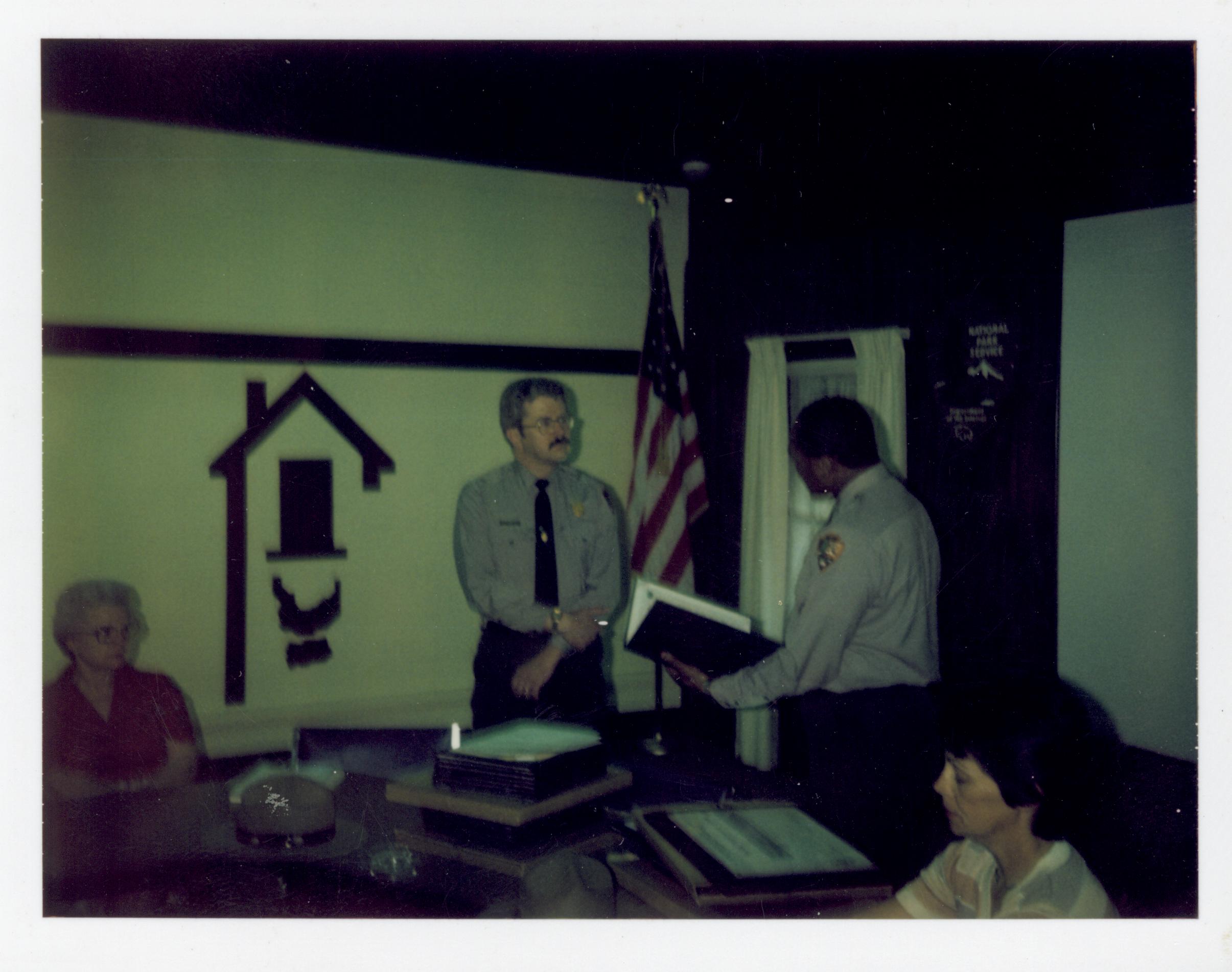 Awards ceremony for staff in Conference Center.  Supt. Gentry Davis gives award to Historian George Painter, Joyce Mavis on left, Rena Lowder on right looking Southwest on second floor awards, staff, Conference Center