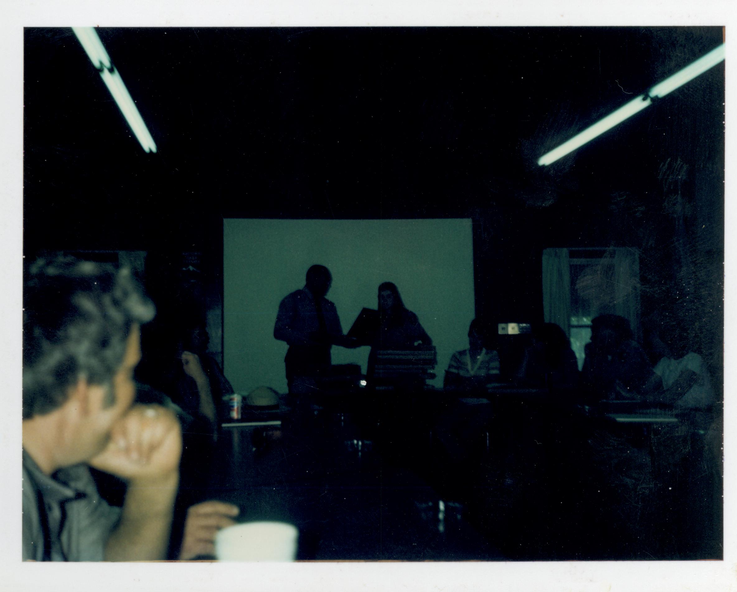 Awards ceremony for staff in Conference Center.  Supt. Gentry Davis gives an award to staff, Andy Antonacci in foreground looking west on second floor awards, staff, Conference Center