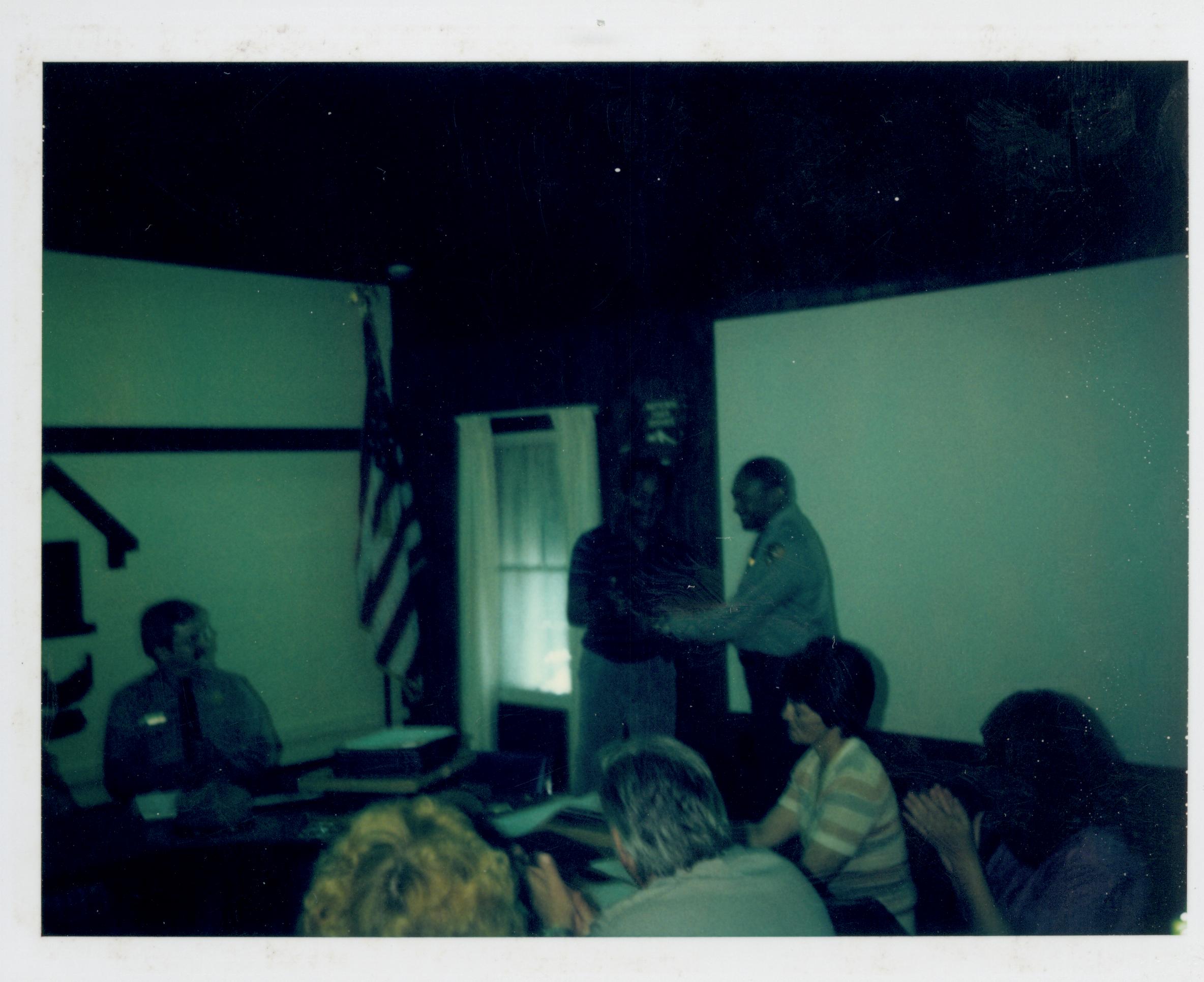 Awards ceremony for staff in Conference Center.  Supt. Gentry Davis gives award to Ranger Reggie ? looking Southwest on second floor awards, staff, Conference Center