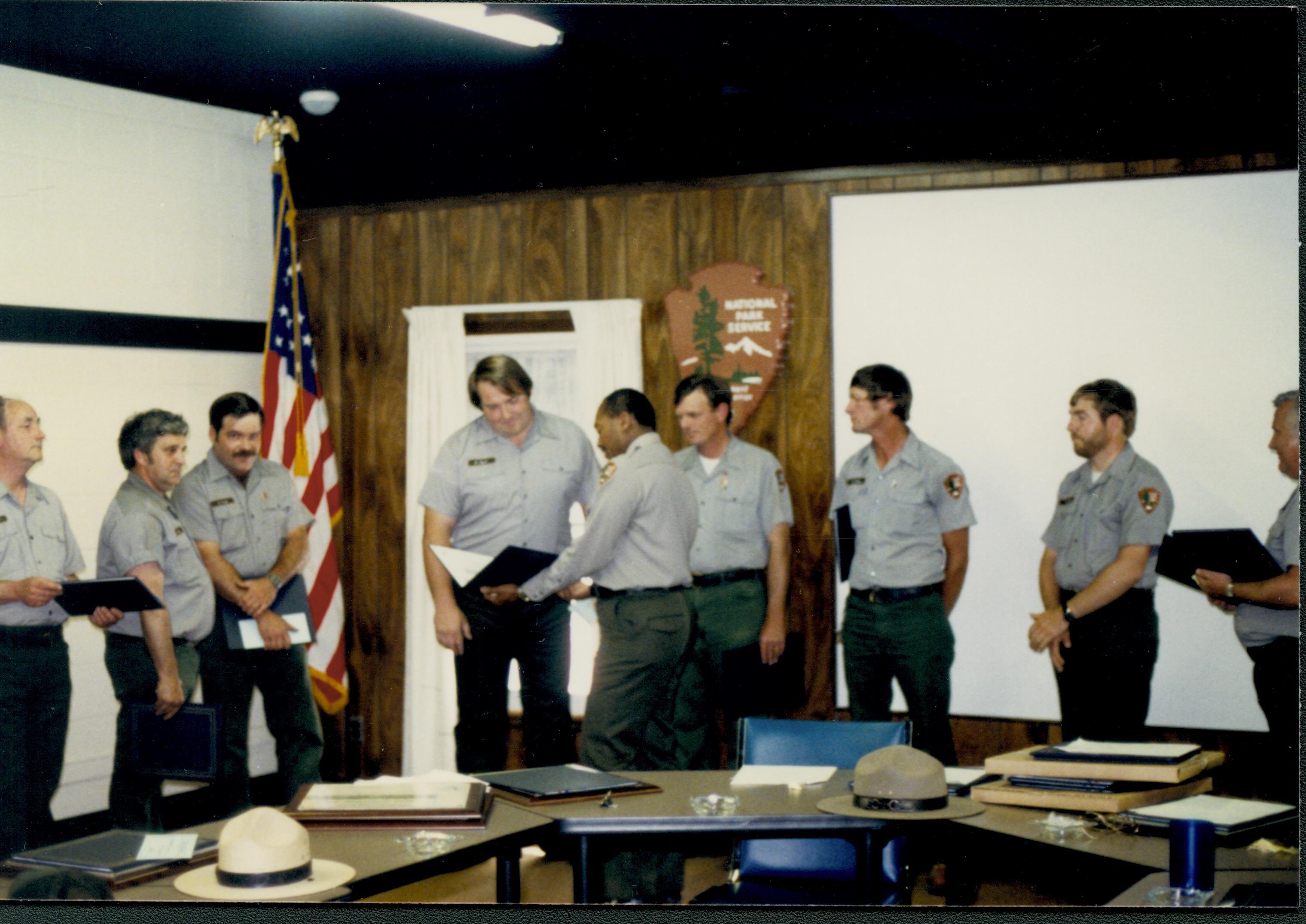 Supt. Gentry Davis giving out special achievement awards to Maint. staff in Conference Center. ? receiving award looking Southwest on second floor awards, staff, Conference Center