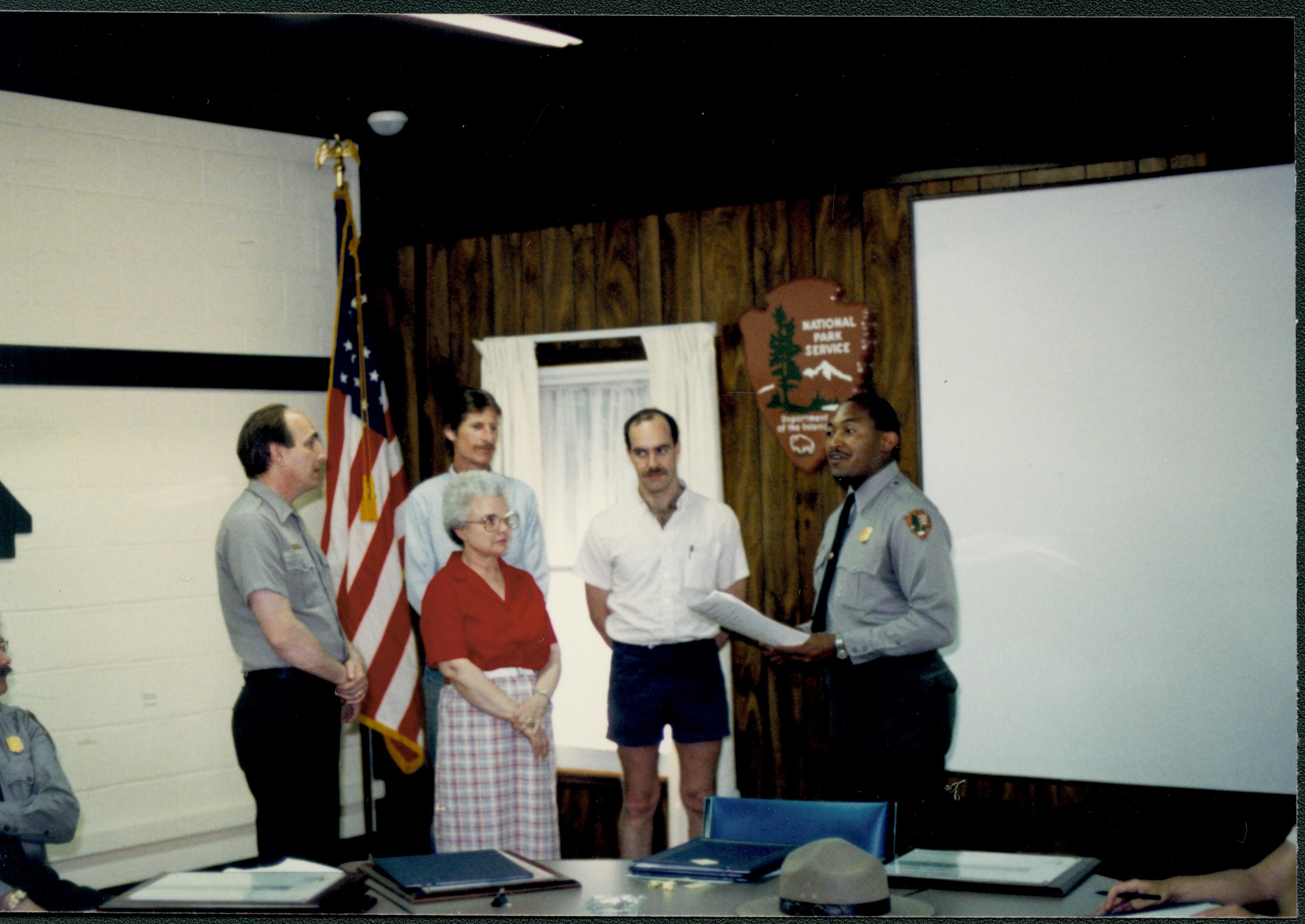 Supt. Gentry Davis giving out special achievement awards to Larry Blake, Joyce Mavis, Jason Hammond, and Kelly Dodsworth in Conference Center looking Southwest on second floor awards, staff, Conference Center