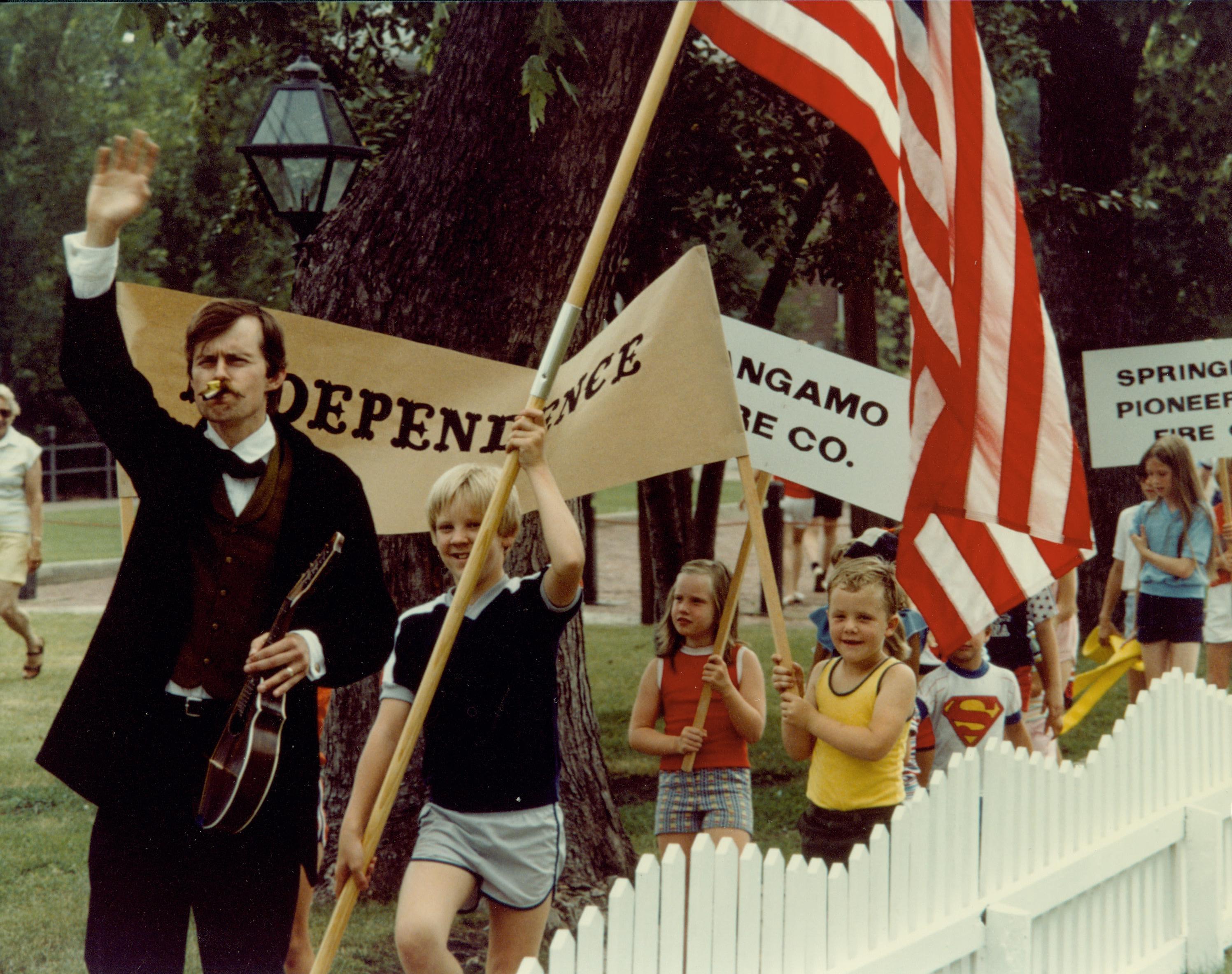 Park Technician, Tom Haraden, leads a parade in the Fourth of July program 11 Interpretive Programs