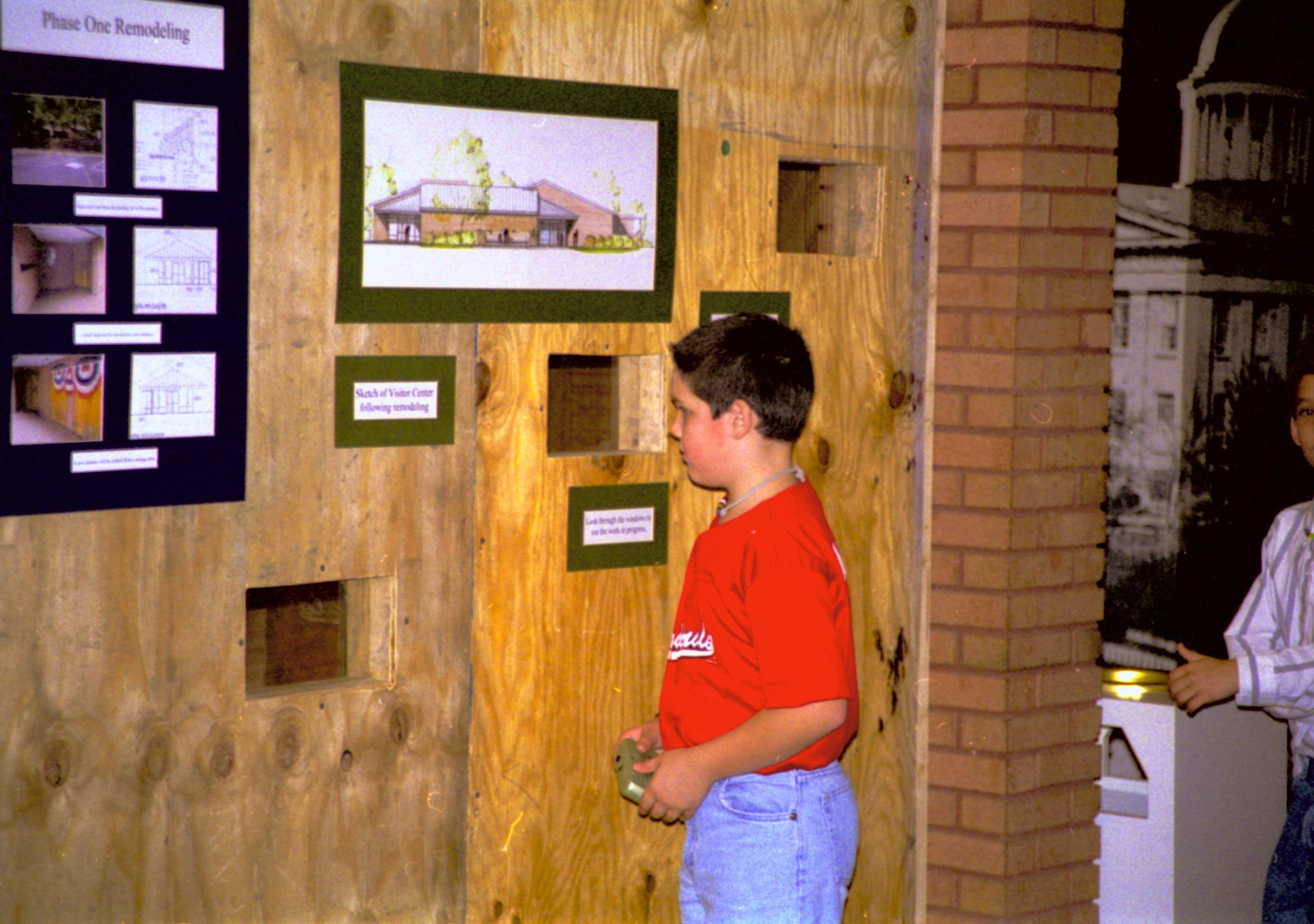 Construction wall and temporary exhibit, and student from Ball-Chatham District Lincoln Home NHS- Visitor Center remodel, exp 16 Visitor Center, remodel