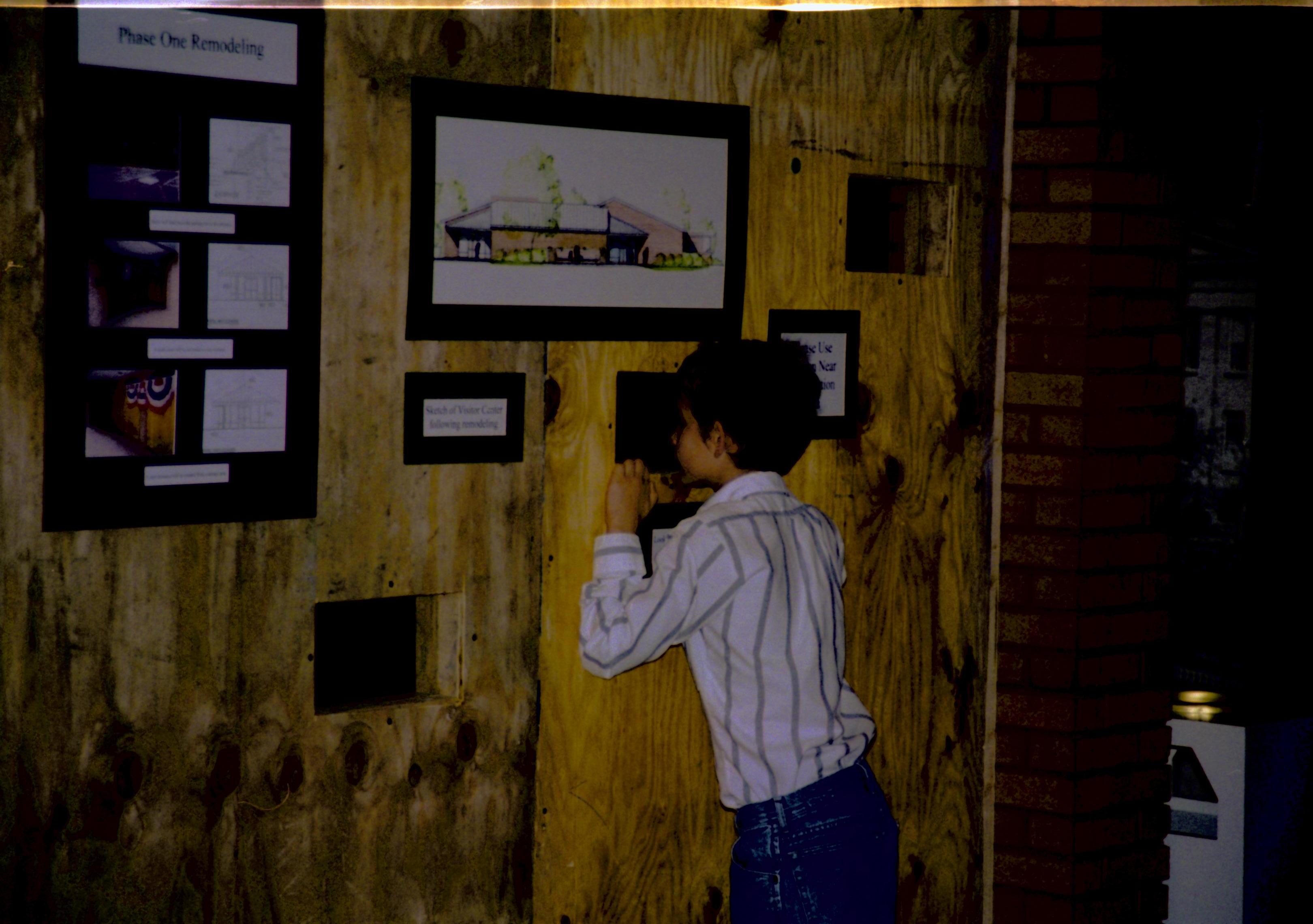 Construction wall and temporary exhibit, and student from Ball-Chatham District Lincoln Home NHS- Visitor Center remodel, exp 17 Visitor Center, remodel