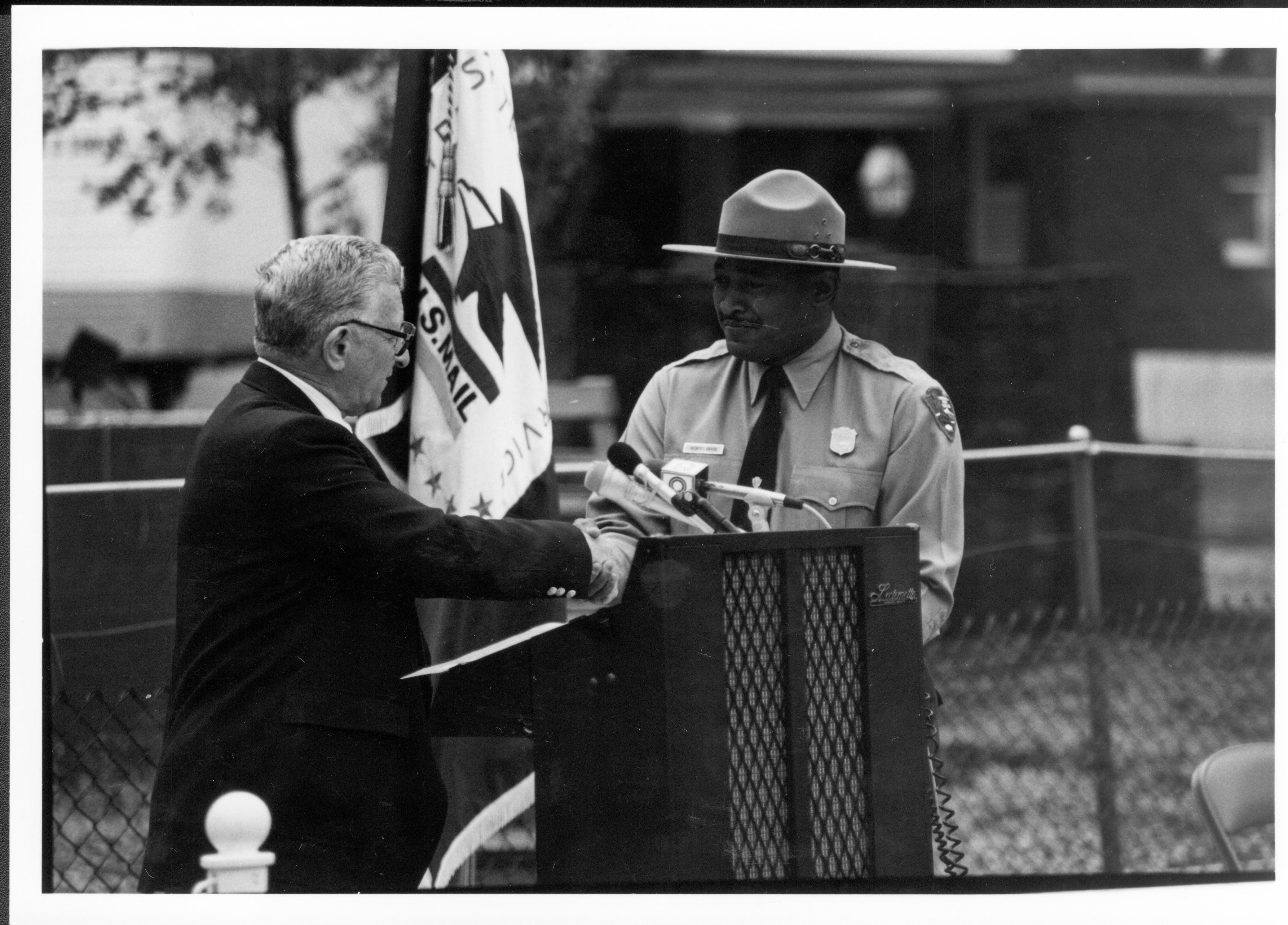 Postage stamp cancellation ceremony, Ossie Langfelder, Mayor, Springfield, IL presents Gentry Davis, Supt. Lincoln Home with citation Lincoln Home NHS- Postage Stamp Cancellation postage stamp, ceremony