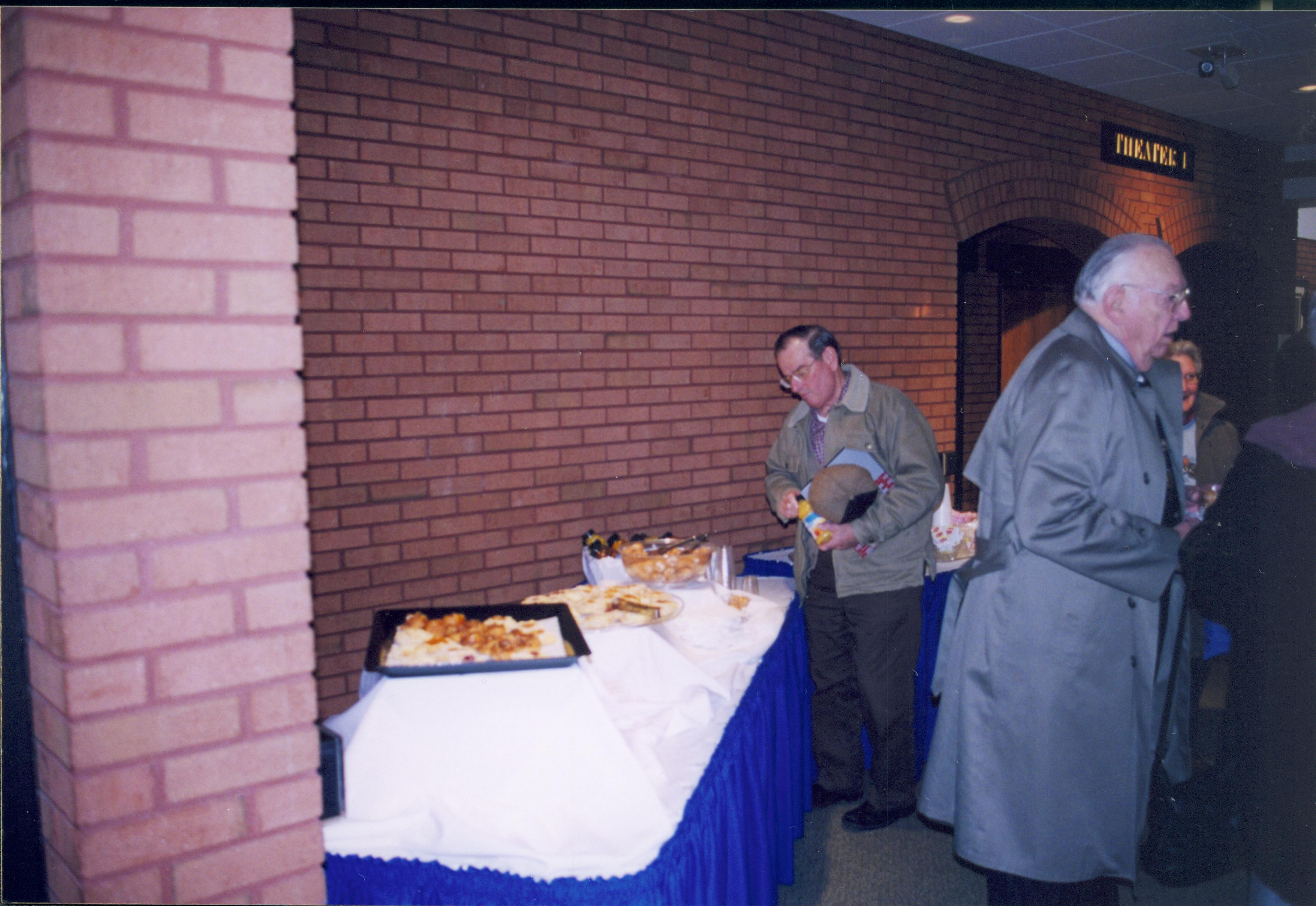 Lincoln's Birthday - visitors enjoying the refreshment table set up in the space between the theaters in Visitor Center Looking Southwest from Theater 2 entrance Lincoln's birthday, refreshments, visitors, Visitor Center