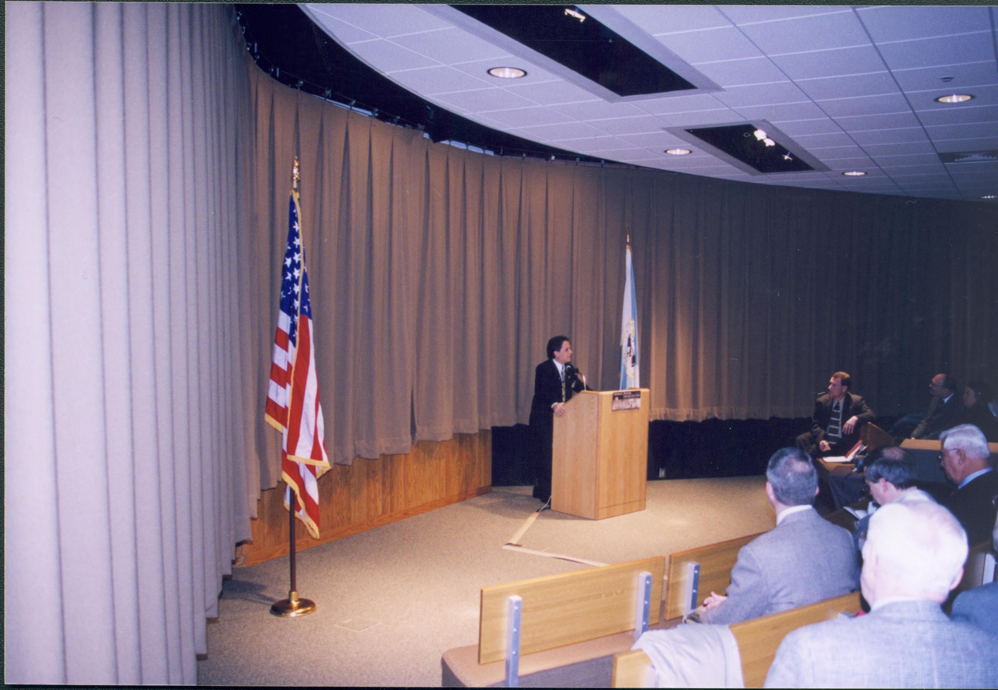 Lincoln's Birthday - Speaker Bruce Levine delivers a lecture to crowd in Visitor Center Theater 1. Historian Tim Townsend listens from front row right. Looking West from side of Theater 1. Lincoln's Birthday, Theater 1, Visitor Center, visitors, staff, lecture, flags, podium