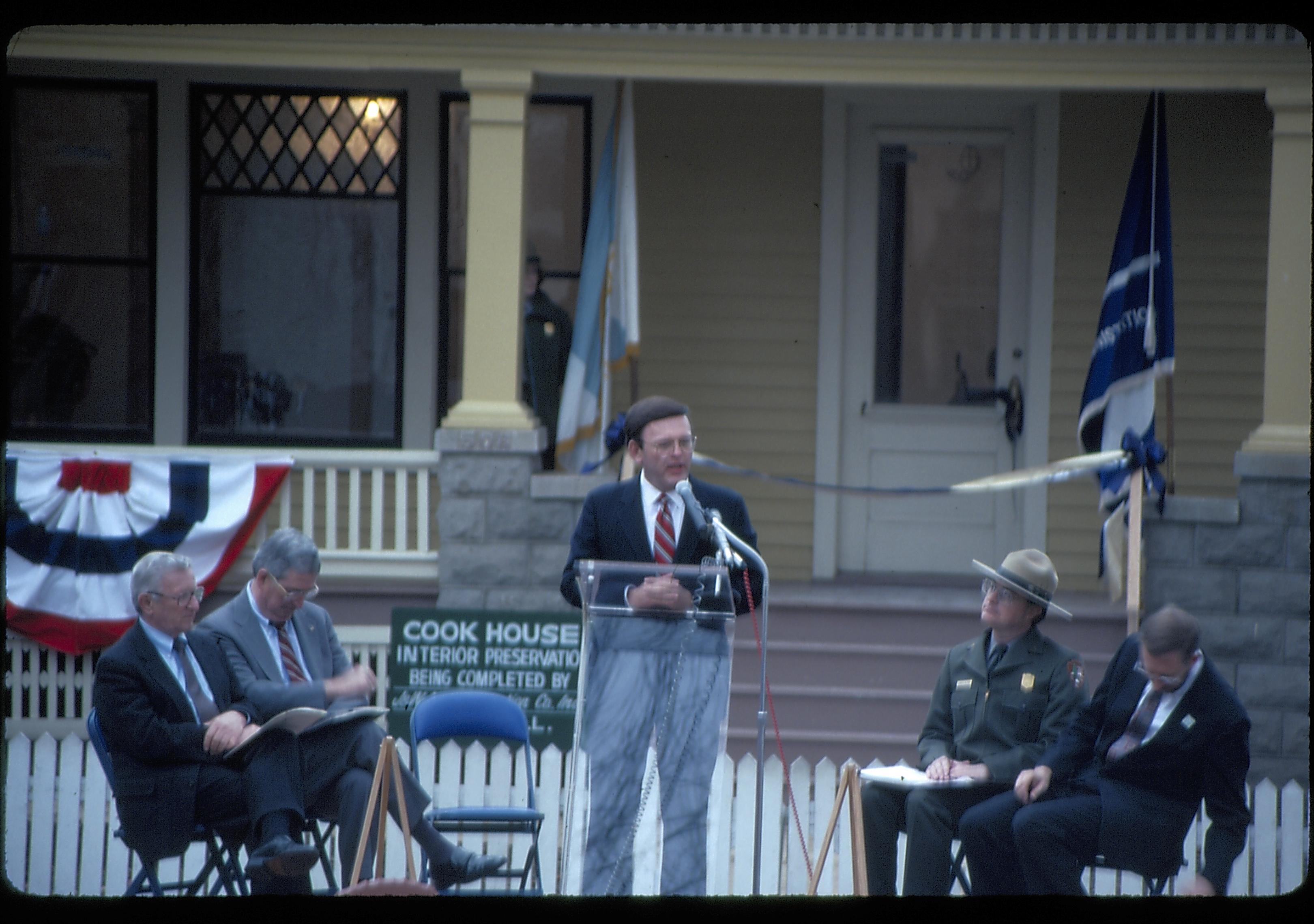 Five men on speakers platform in front of Cook house Lincoln Home NHS- Cook House Re-opening  Cook, ceremony