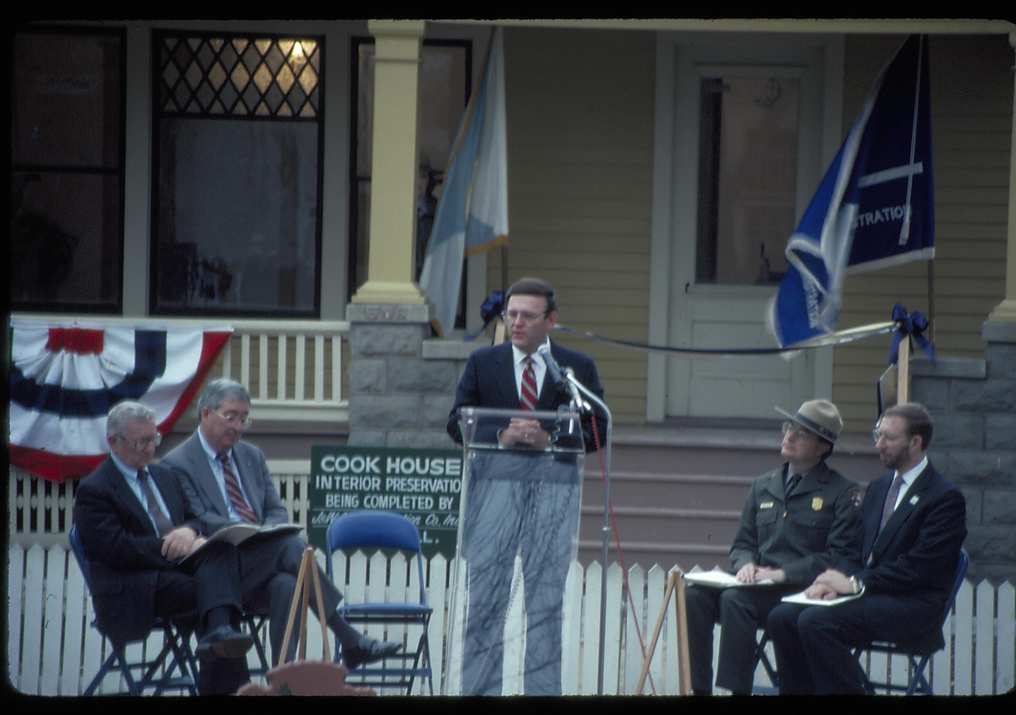 Five men on speakers platform in front of Cook house Lincoln Home NHS- Cook House Re-opening  Cook, ceremony