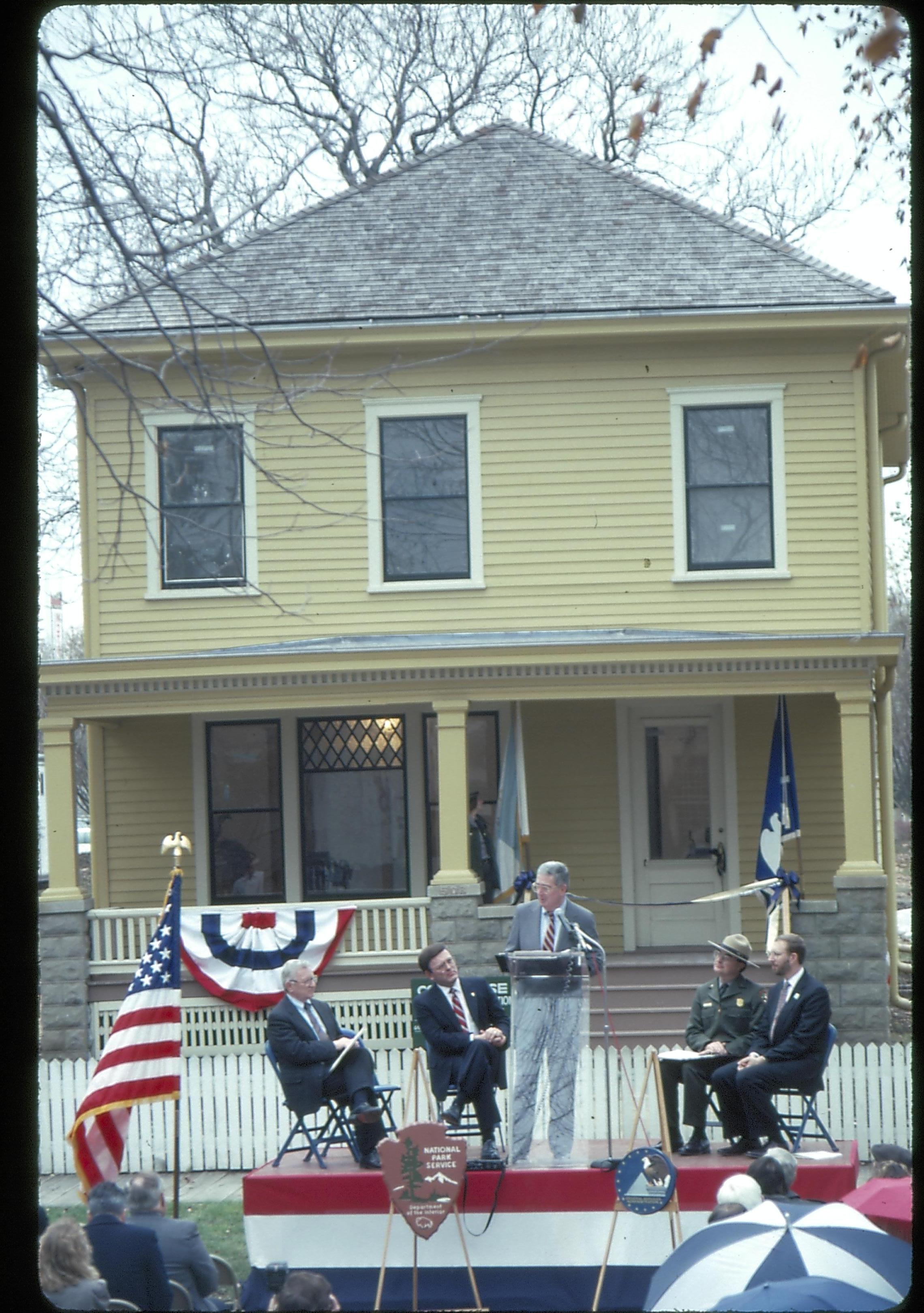 Five men on speakers platform in front of Cook house Lincoln Home NHS- Cook House Re-opening  Cook, ceremony