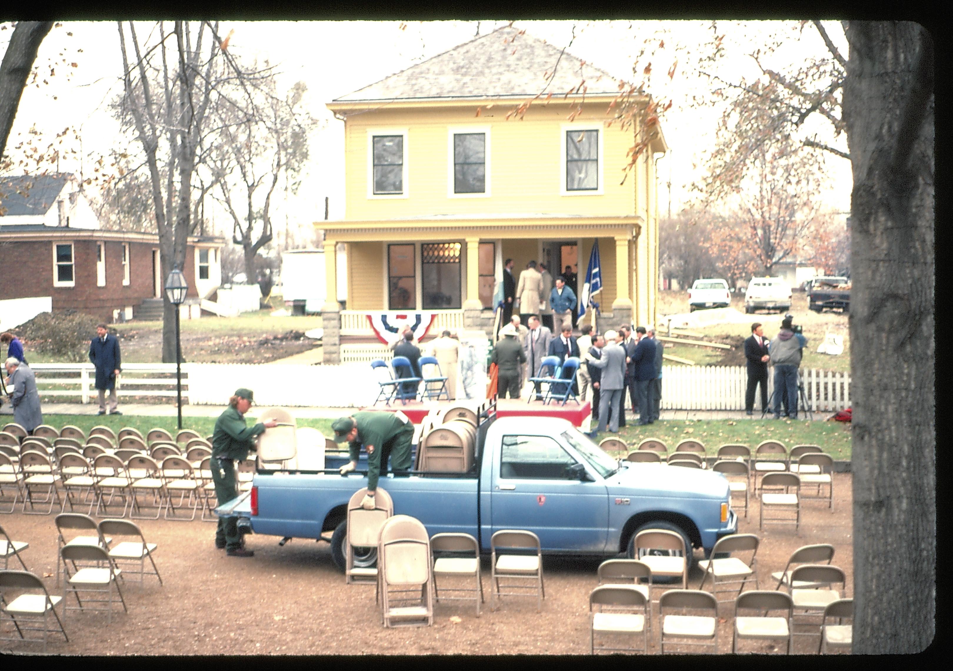 Loading up chairs after ceremoney in front of Cook house. Lincoln Home NHS- Cook House Re-opening  Cook, ceremony