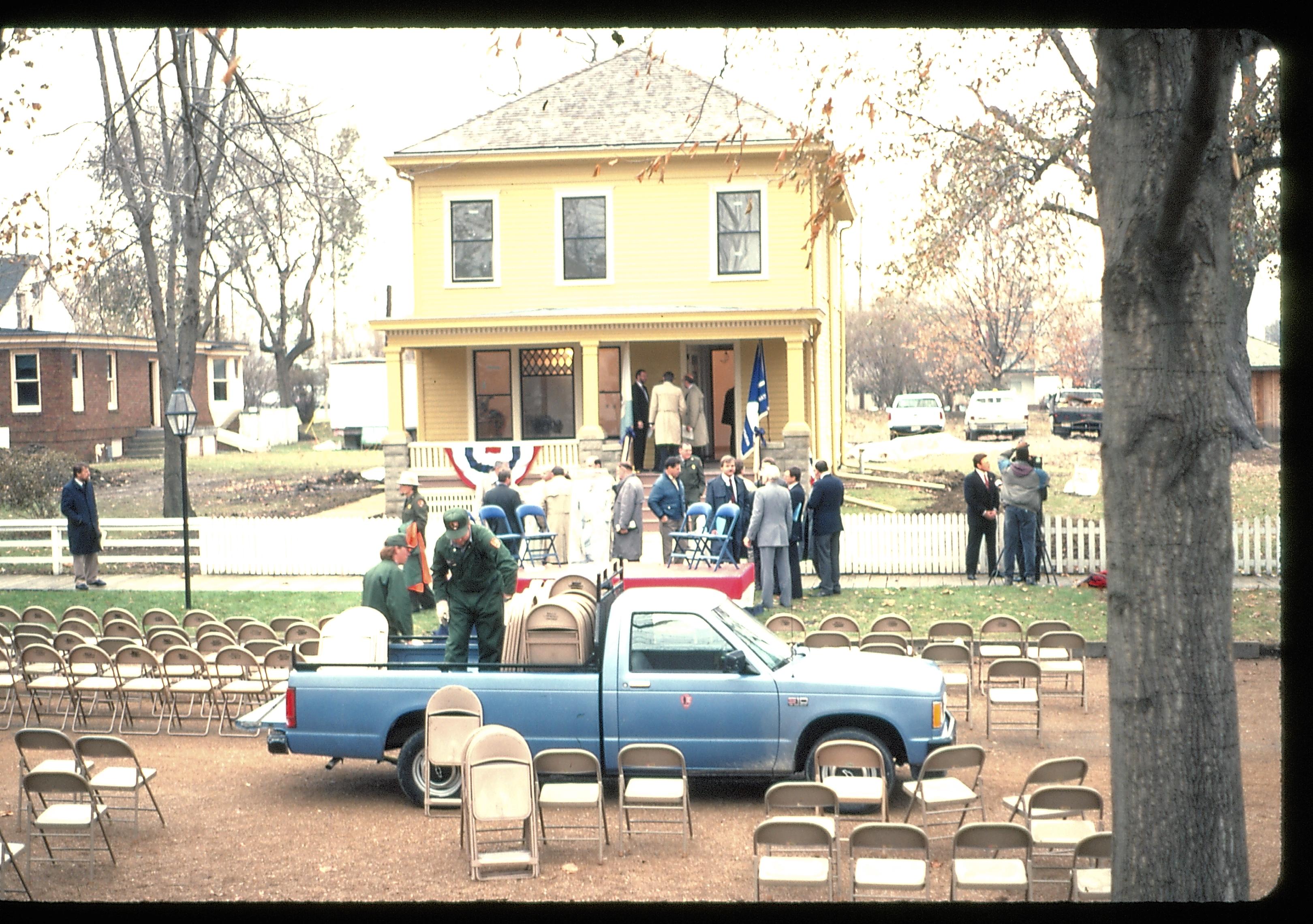 Loading up chairs after ceremoney in front of Cook house. Lincoln Home NHS- Cook House Re-opening  Cook, ceremony