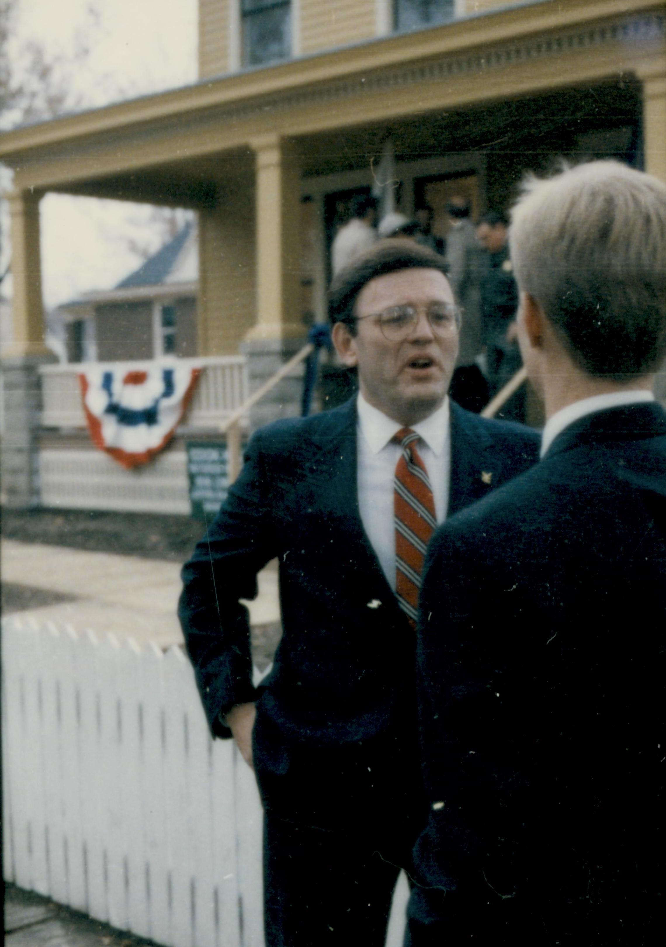 Two men standing, talking in front of Cook house. Lincoln Home NHS- Cook House Re-opening, 2 Cook, ceremony