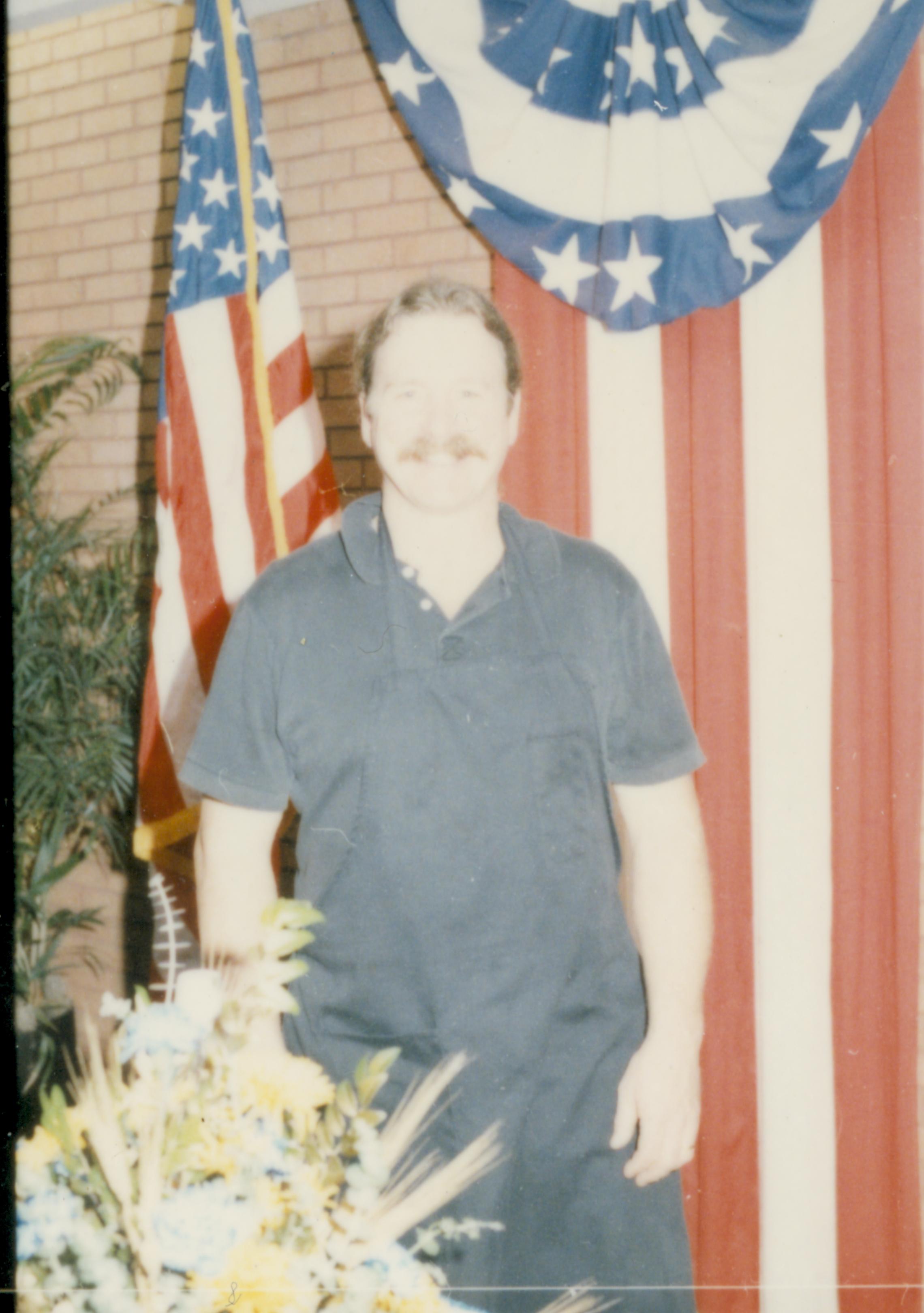 Man standing in front of American flag. Lincoln Home NHS- Cook House Re-opening, 2 Cook, ceremony, reception