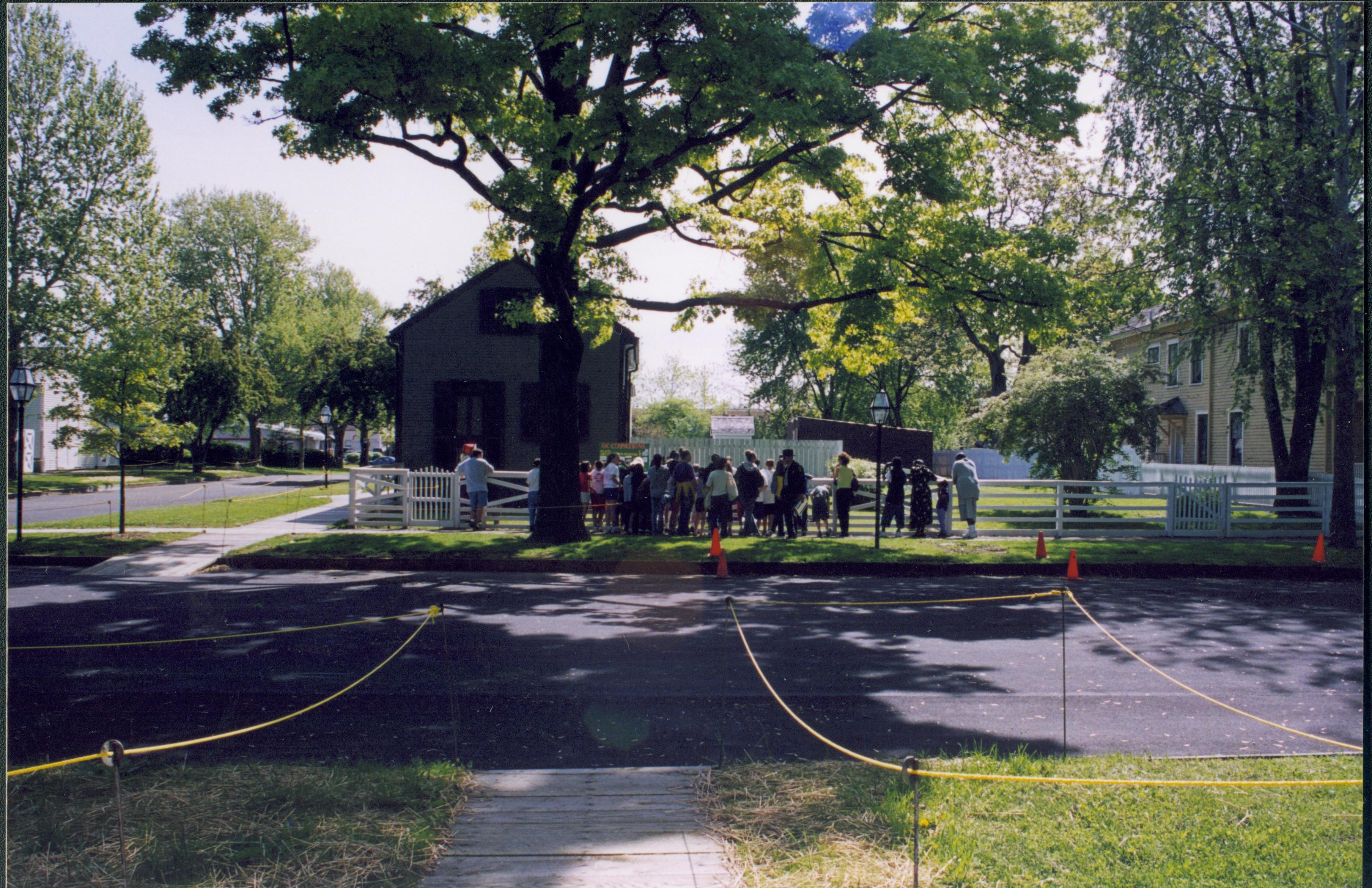 Dubois School Living History program- students perform skit describing 19th century occupations in front of the Arnold House while school group and parents watch.  Cook House on far right. Lincoln Barn on far left. Looking East from in front of Corneau House Dubois School, living history, Arnold, students, school groups, Cook, Lincoln Barn, 8th Street