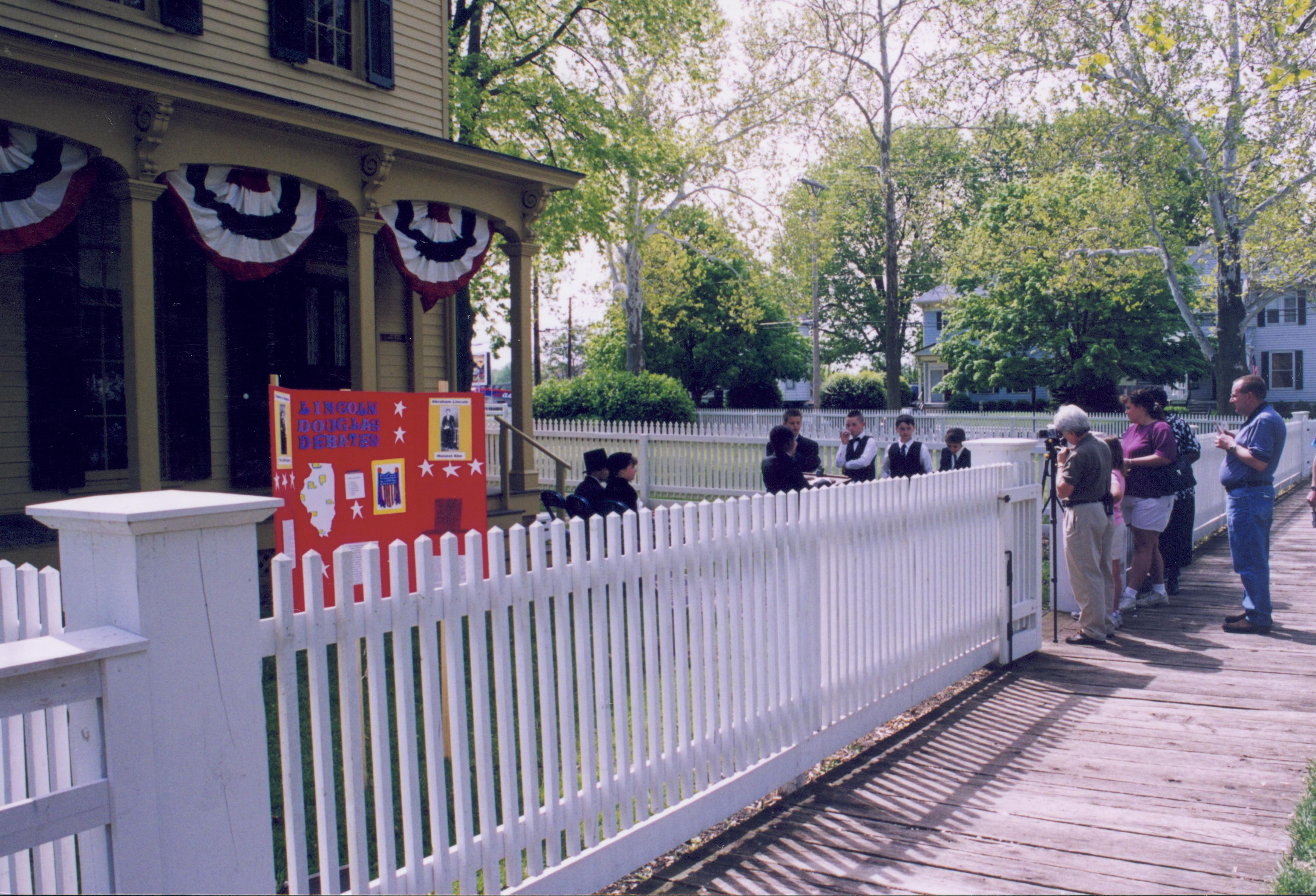 Dubois School Living History program - students perform skits about the Lincoln-Douglas debates in front of the Robinson house. Looking South/Southeast from boardwalk East of 8th Street Dubois School, living history, students, visitors, Robinson