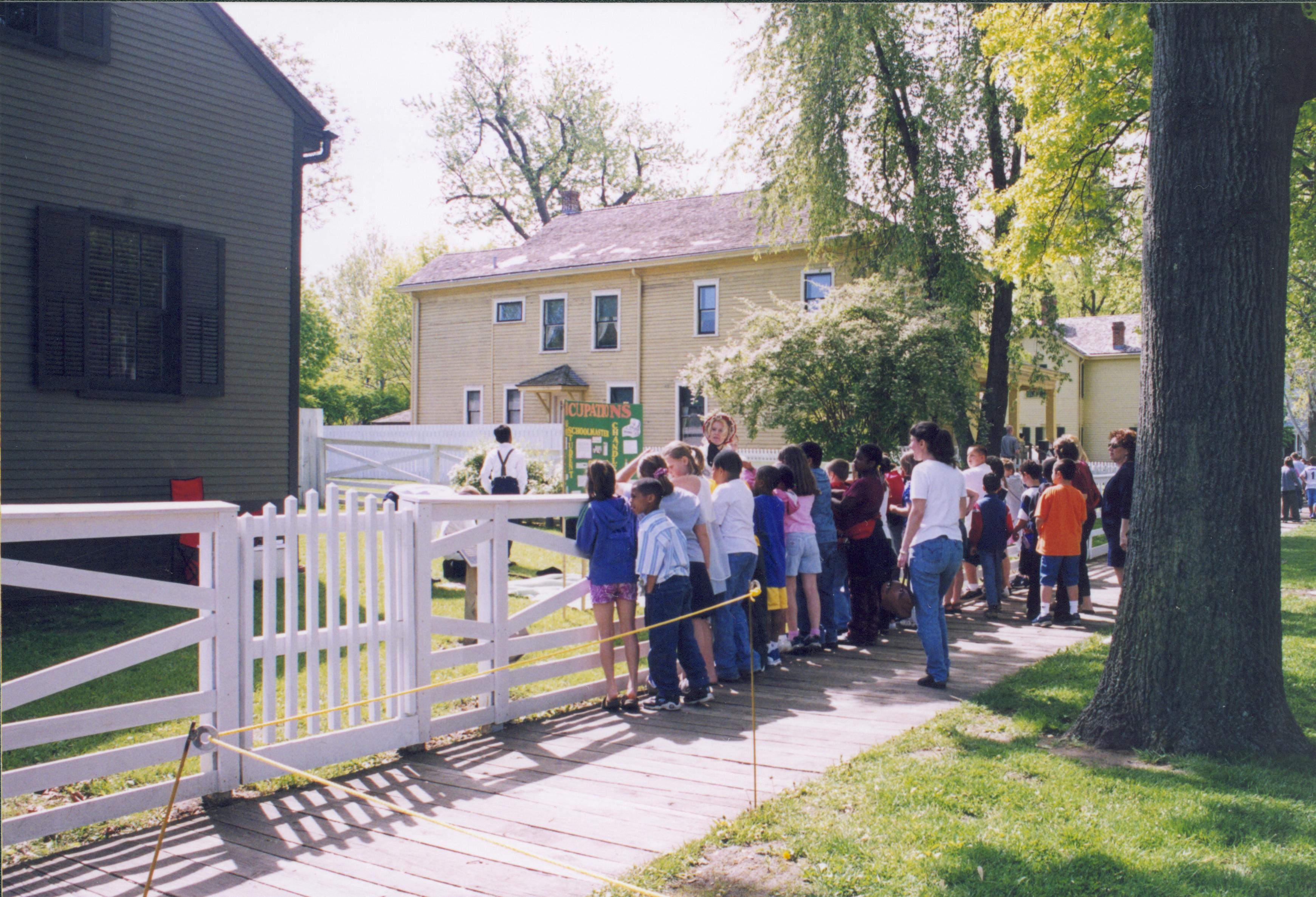 Dubois School Living History program - students portray different occupations from the 19th century in Arnold house yard while a school group and parents watch.  Arnold House on left. Cook and Robinson Houses in background center and right. Looking Southeast from 8th and Jackson Street intersection Dubois School, living history, Arnold, Cook, Robinson, students, school groups, 