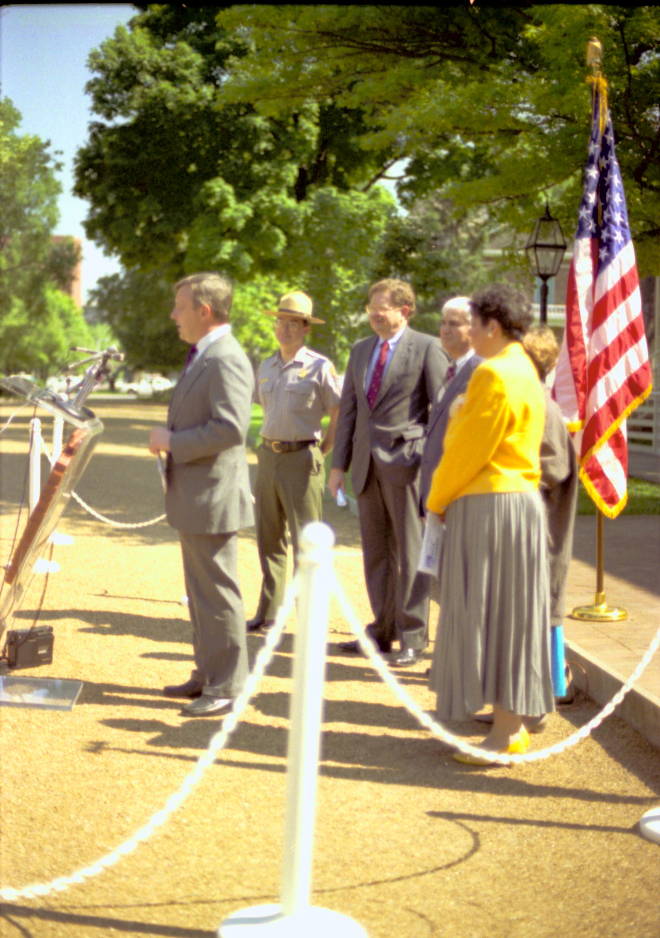 Man speaking with others standing behind. Lincoln Home NHS- Durbin, 24C, artifact #744 press, conference, interview