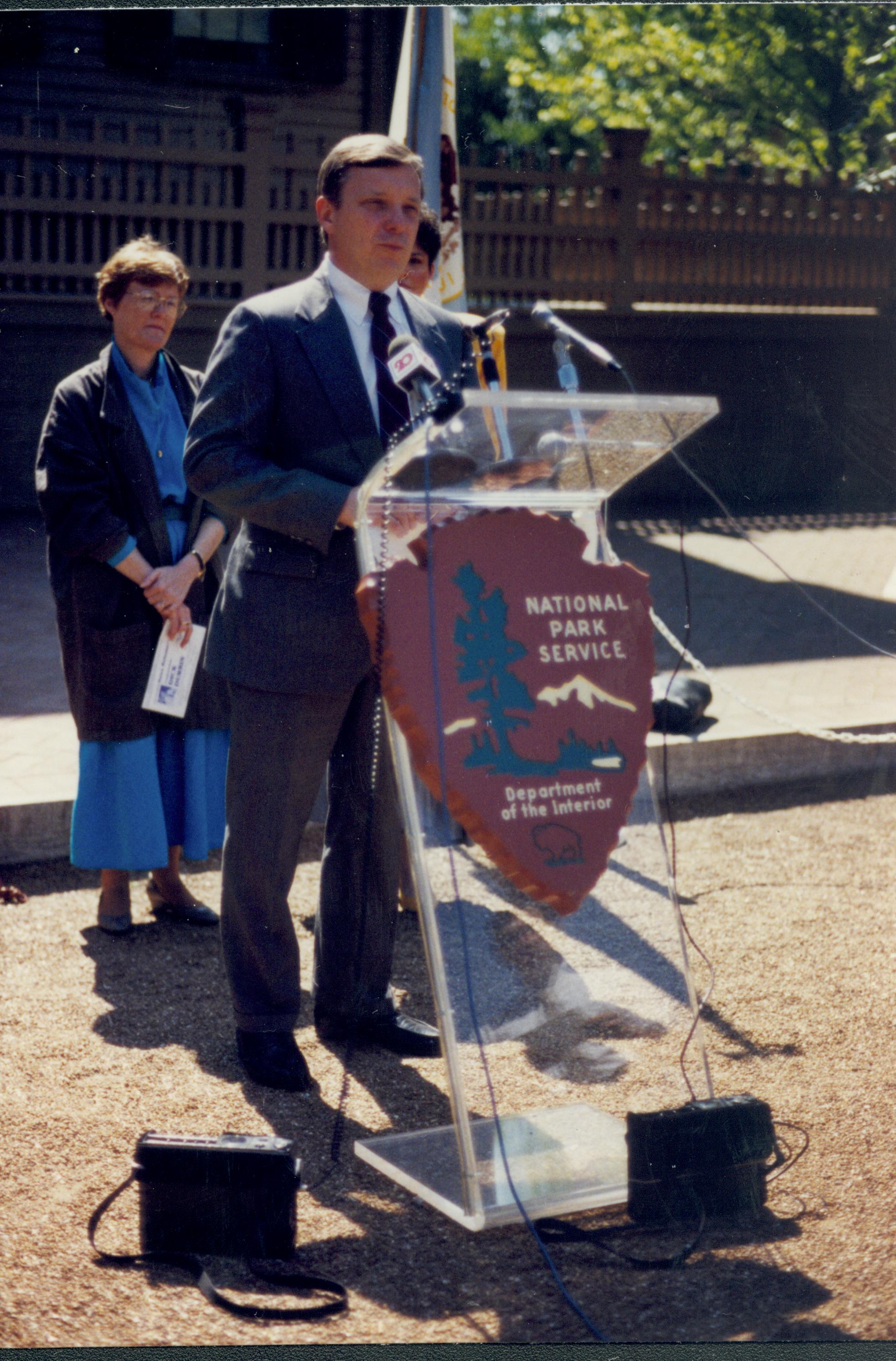 Man speaking at podium. Lincoln Home NHS- Durbin 3581381 interview, conference