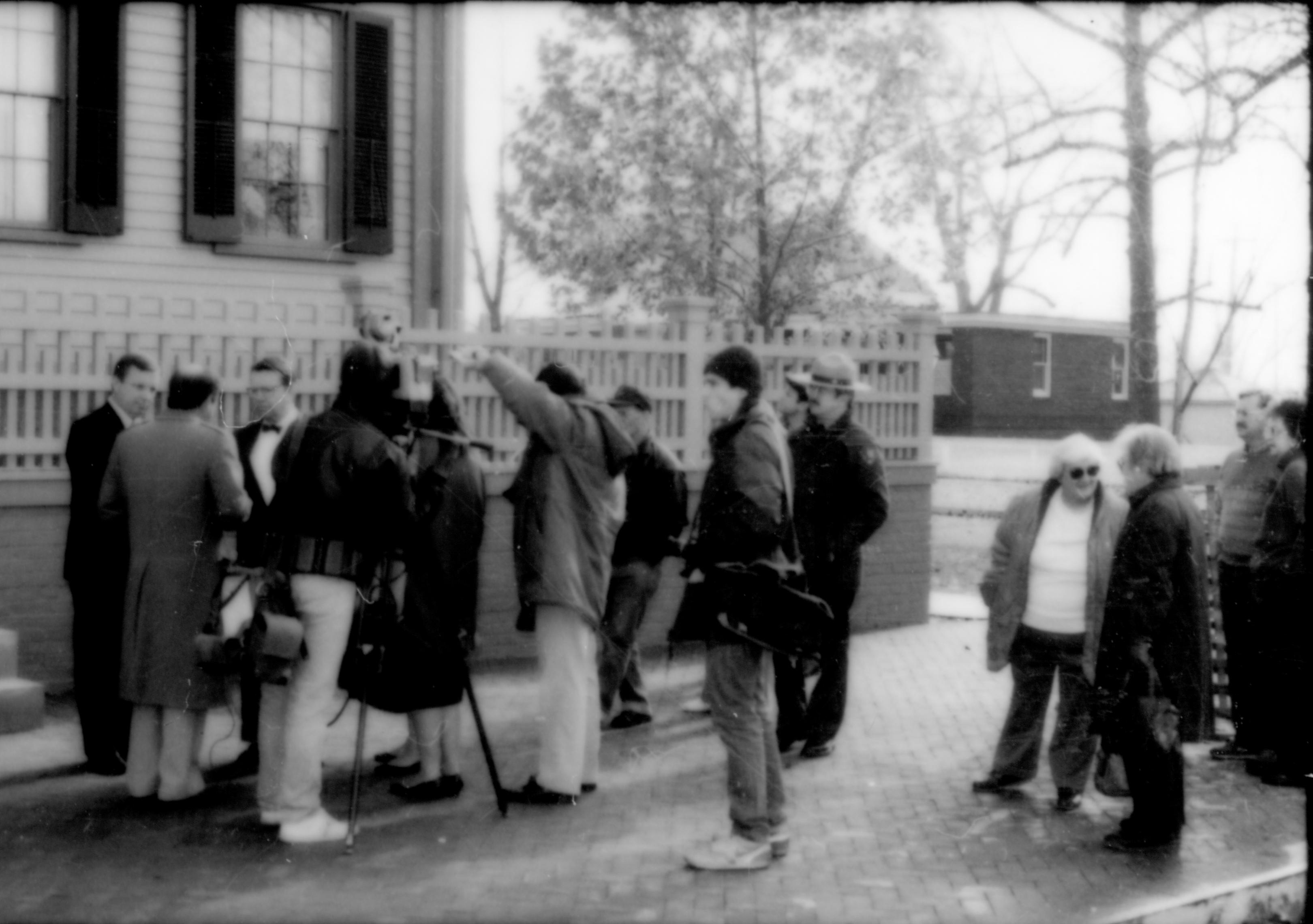 People standing on sidewalk in front of house. Lincoln Home NHS- Durbin and Simon, 77 Durbin, Simon, visit