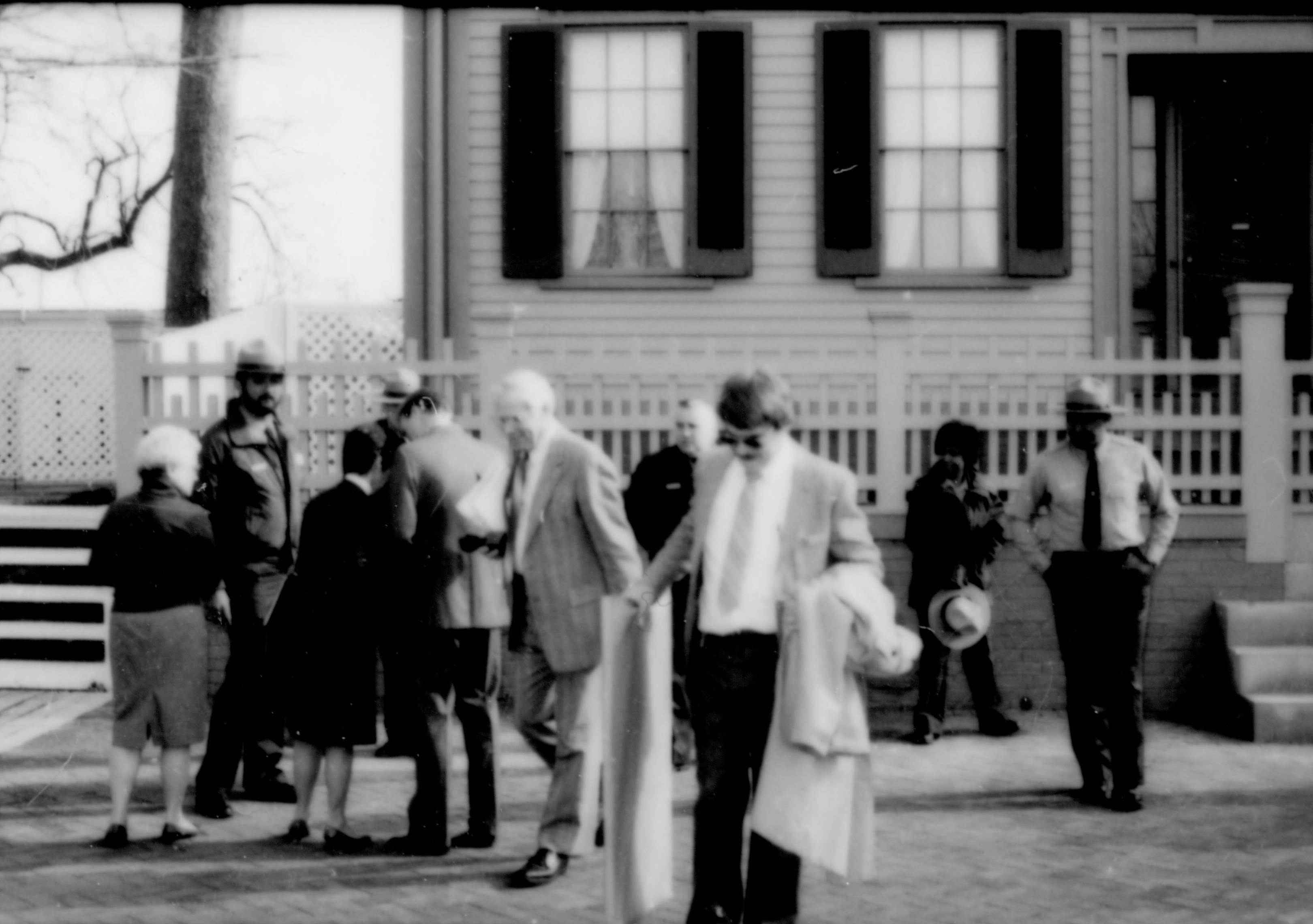 People standing on sidewalk in front of house. Lincoln Home NHS- Durbin and Simon, 77 Durbin, Simon, visit