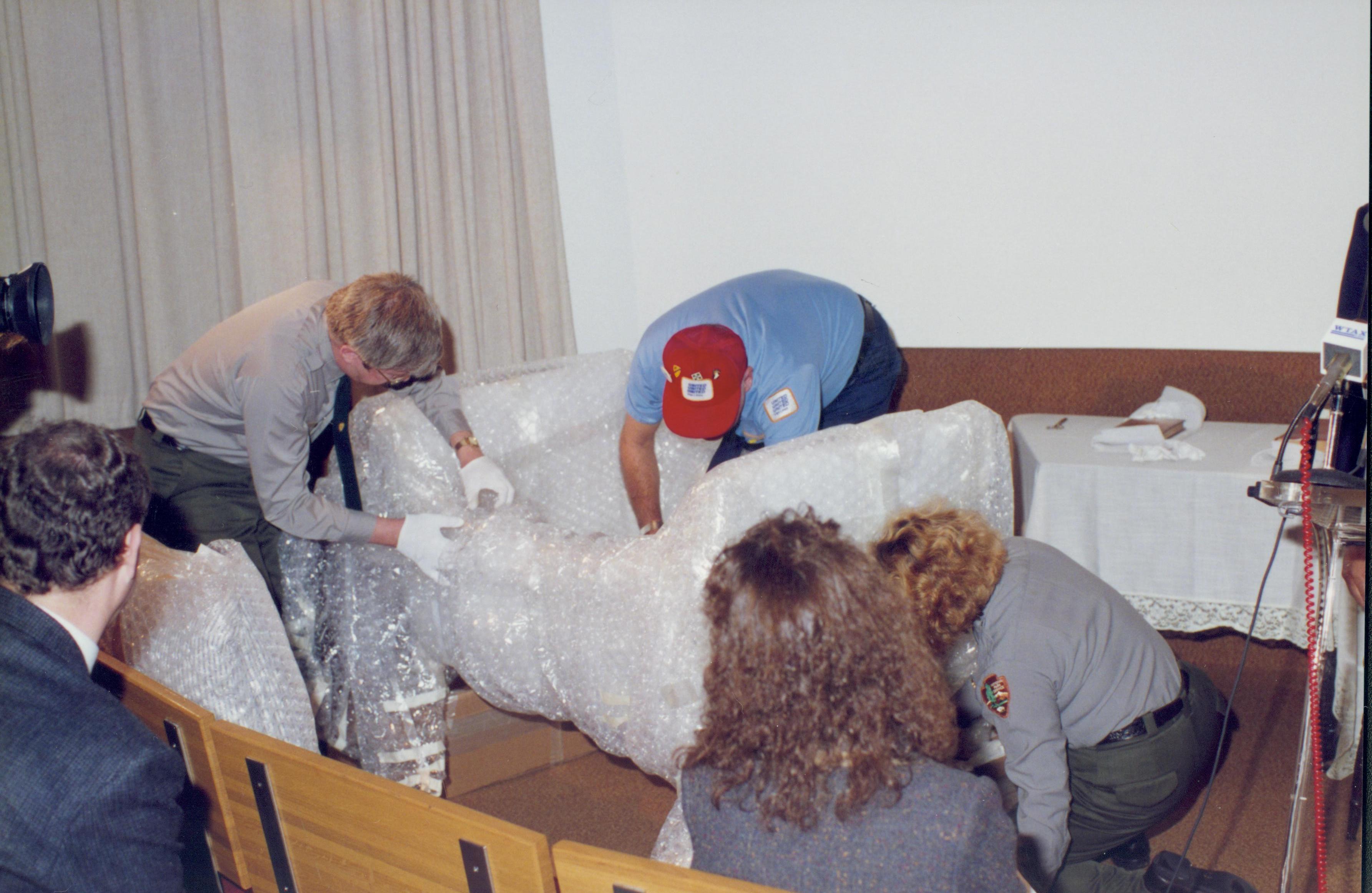 Workers unwrapping furniture. Lincoln Home NHS- Bring Furniture Back Home furniture, cradle, conference