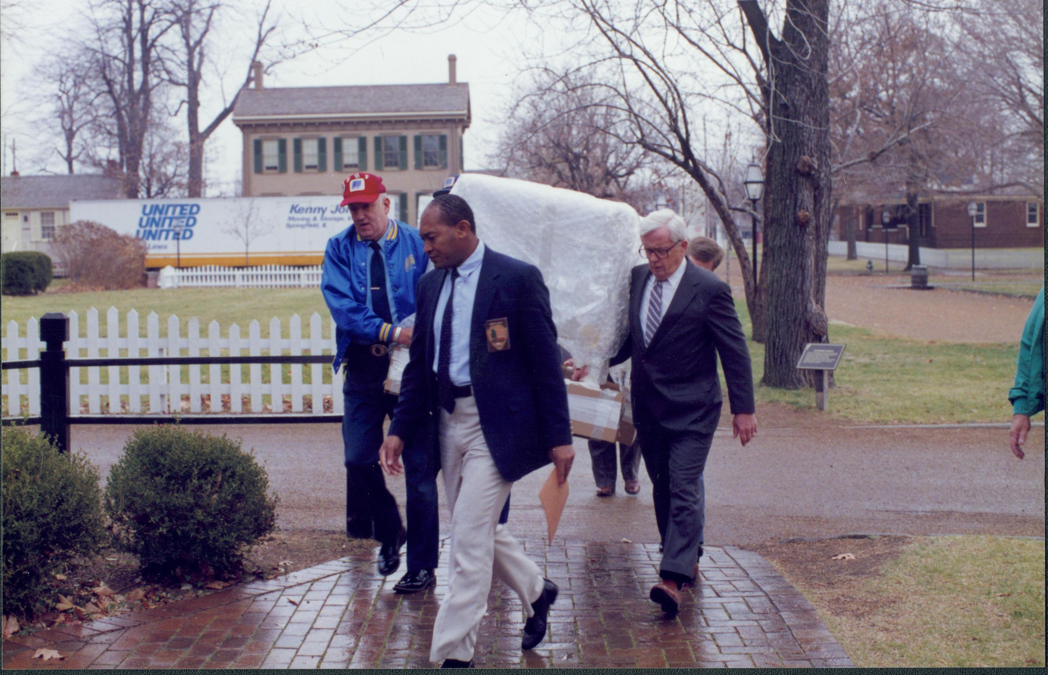 Men carrying furniture. Lincoln Home NHS- Bring Furniture Back Home furniture, conference, cradle