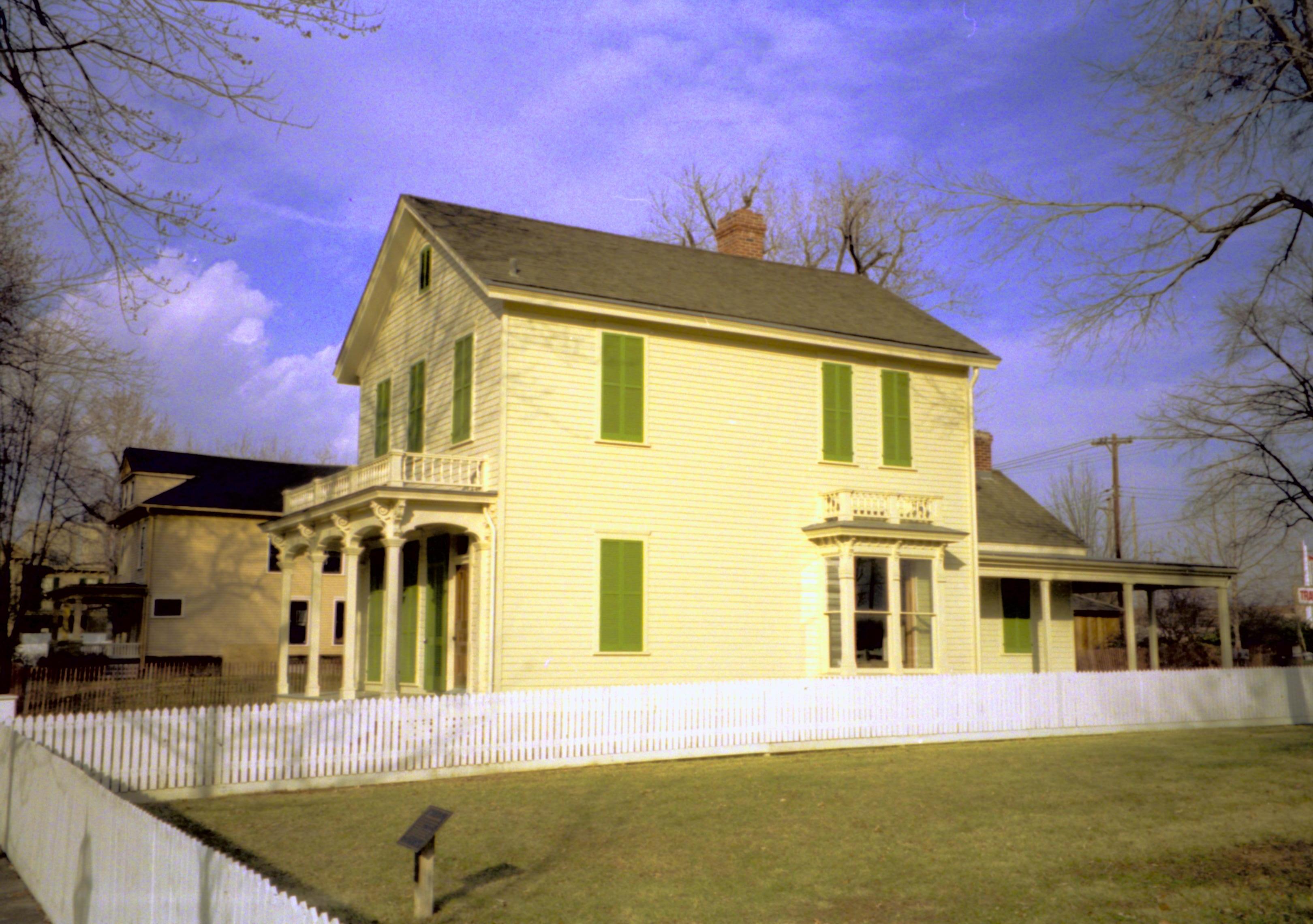 Side view of yellow house with green shutters. Lincoln Home NHS- Bring Furniture Back Home, 79A Robinson