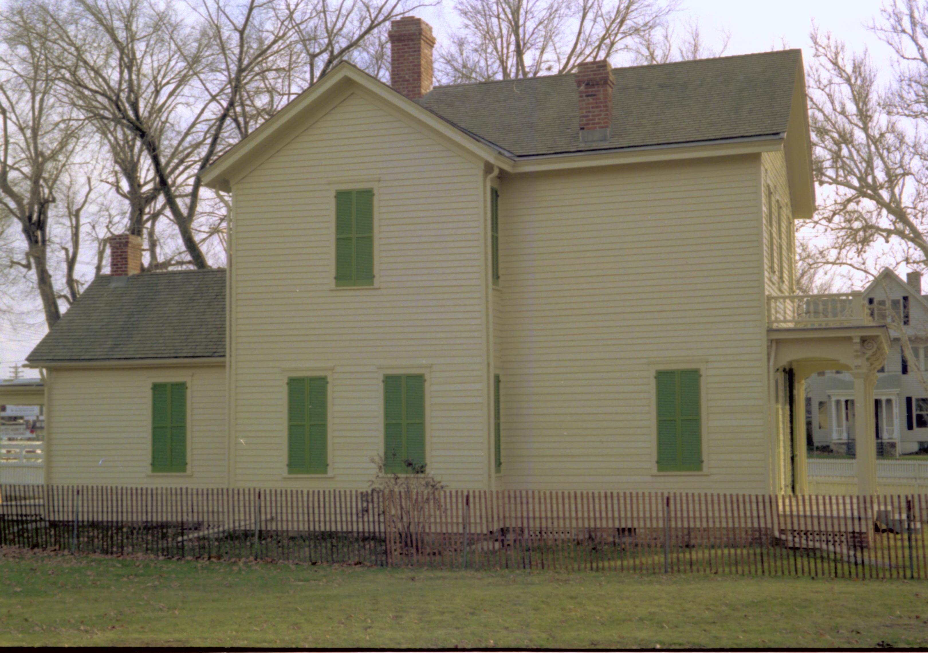 Side view of yellow house with green shutters. Lincoln Home NHS- Bring Furniture Back Home, 79A Robinson