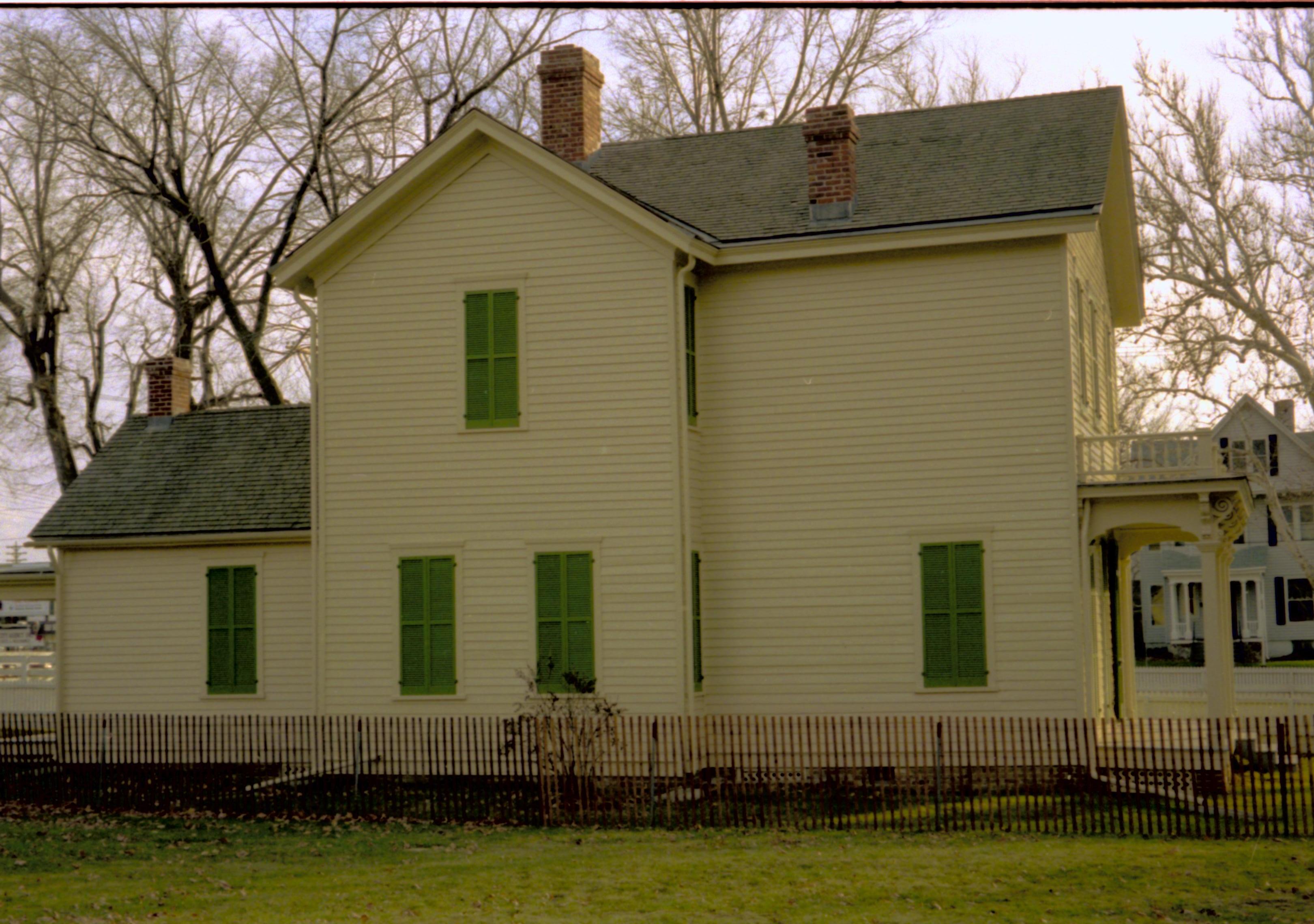 Side view of yellow house with green shutters. Lincoln Home NHS- Bring Furniture Back Home, 79A Robinson