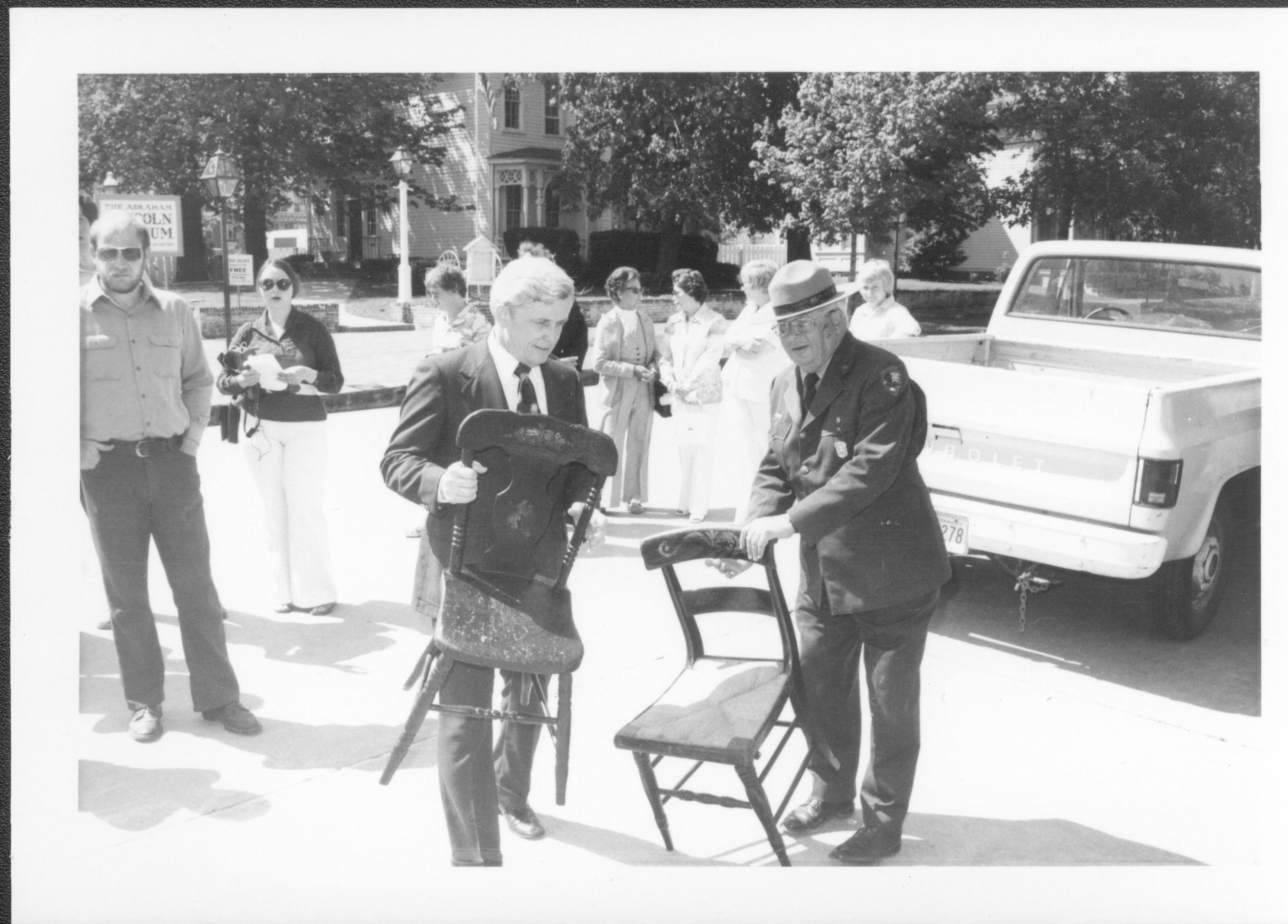 Two men carrying chairs. Lincoln Home NHS- Bring Furniture Back Home, neg 4 class #1190, class 8 pic 4 furniture, return