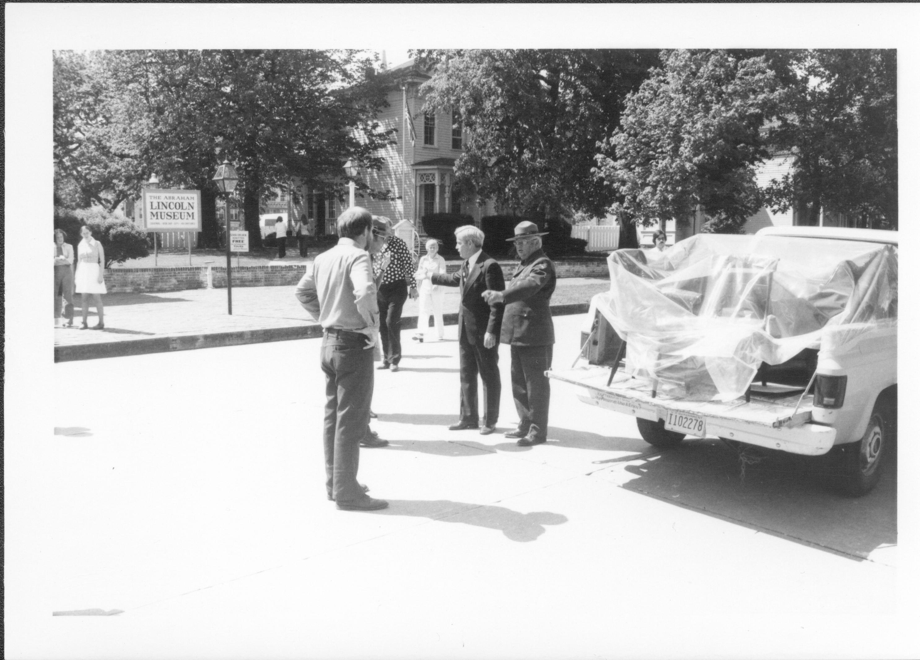 Three men standing in the street next to pick-up truck. Lincoln Home NHS- Bring Furniture Back Home, neg #2 class #1190, class 8 pic 2 furniture, return