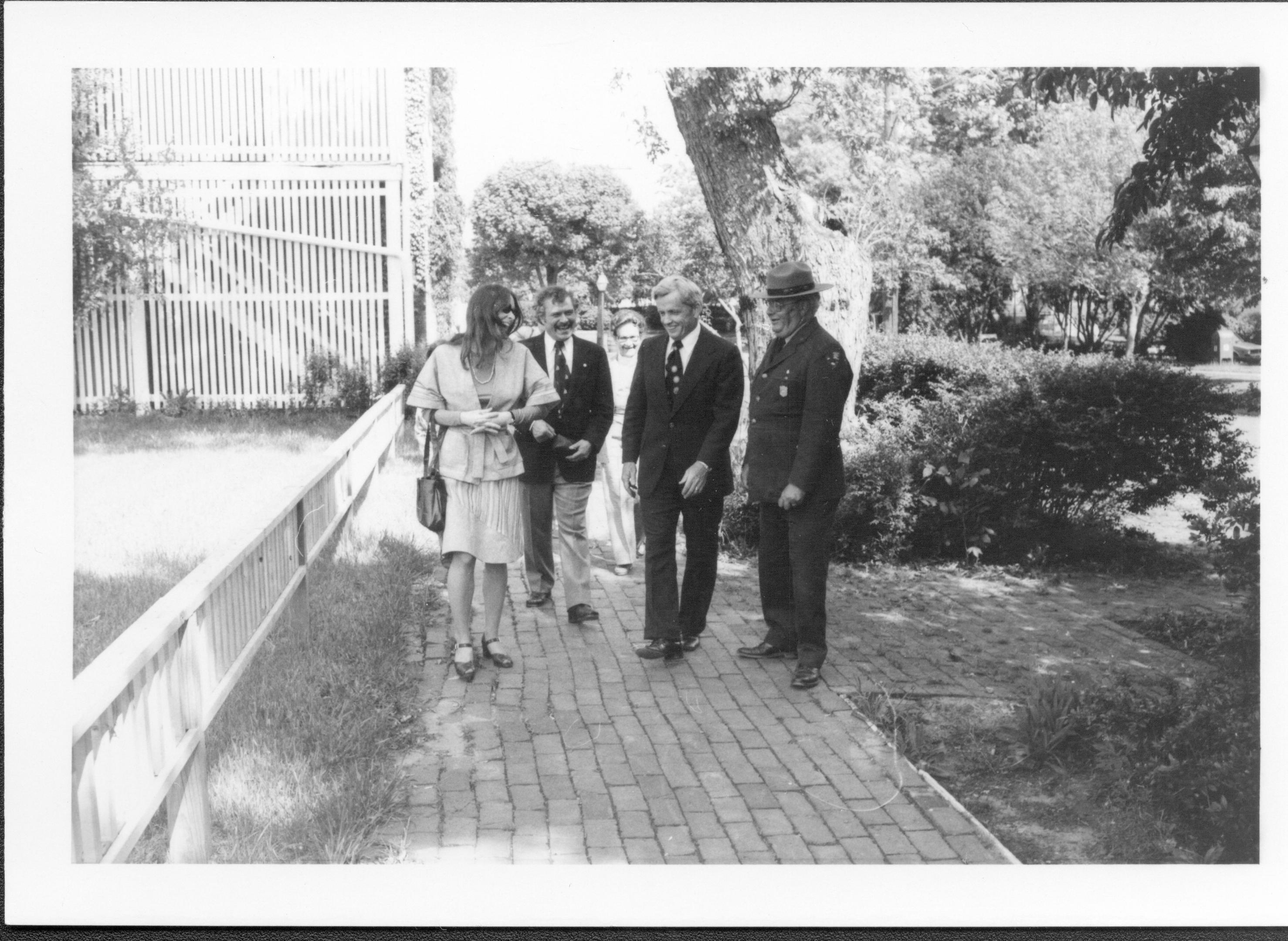 Four people walking on brick walk. Lincoln Home NHS- Bring Furniture Back Home, neg #35 class #1190, class 8 pic 35 furniture, return