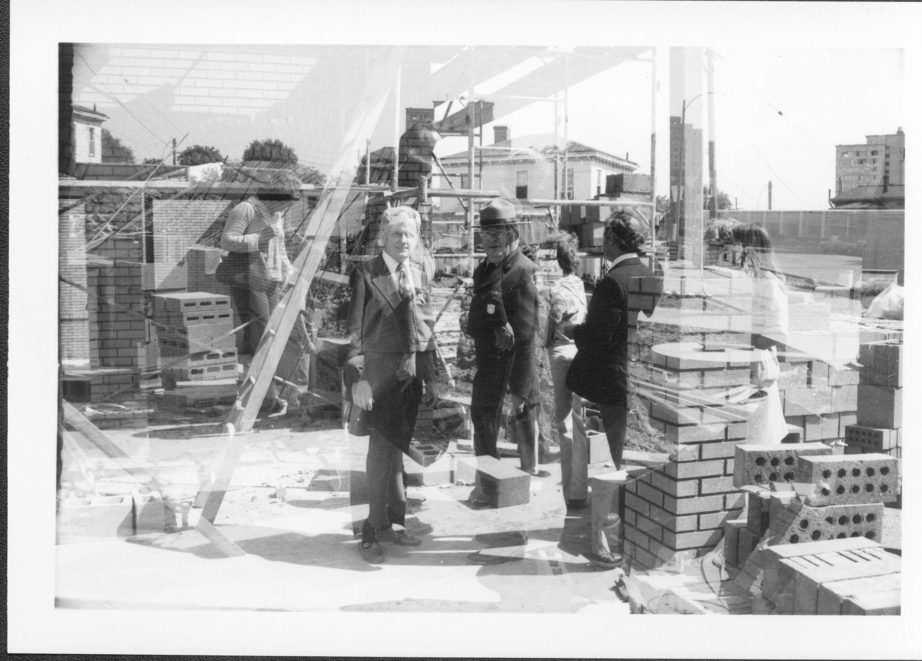 Three people standing in construction zone. Lincoln Home NHS- Bring Furniture Back Home, neg #36 class #1190, class 8 pic 36 furniture, return