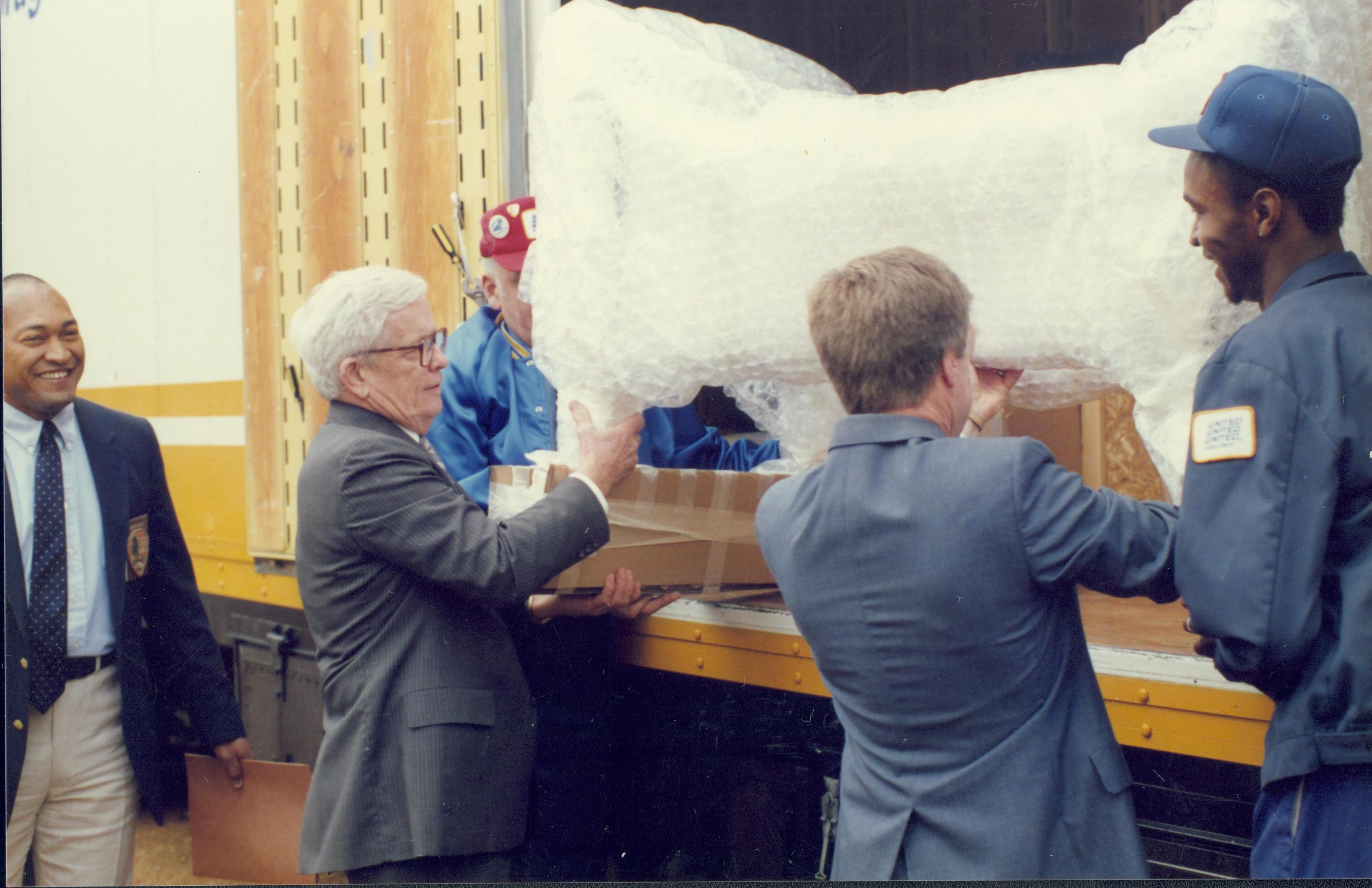 Two men taking objects out of box. Lincoln Home NHS- Bring Furniture Back Home furniture, moving