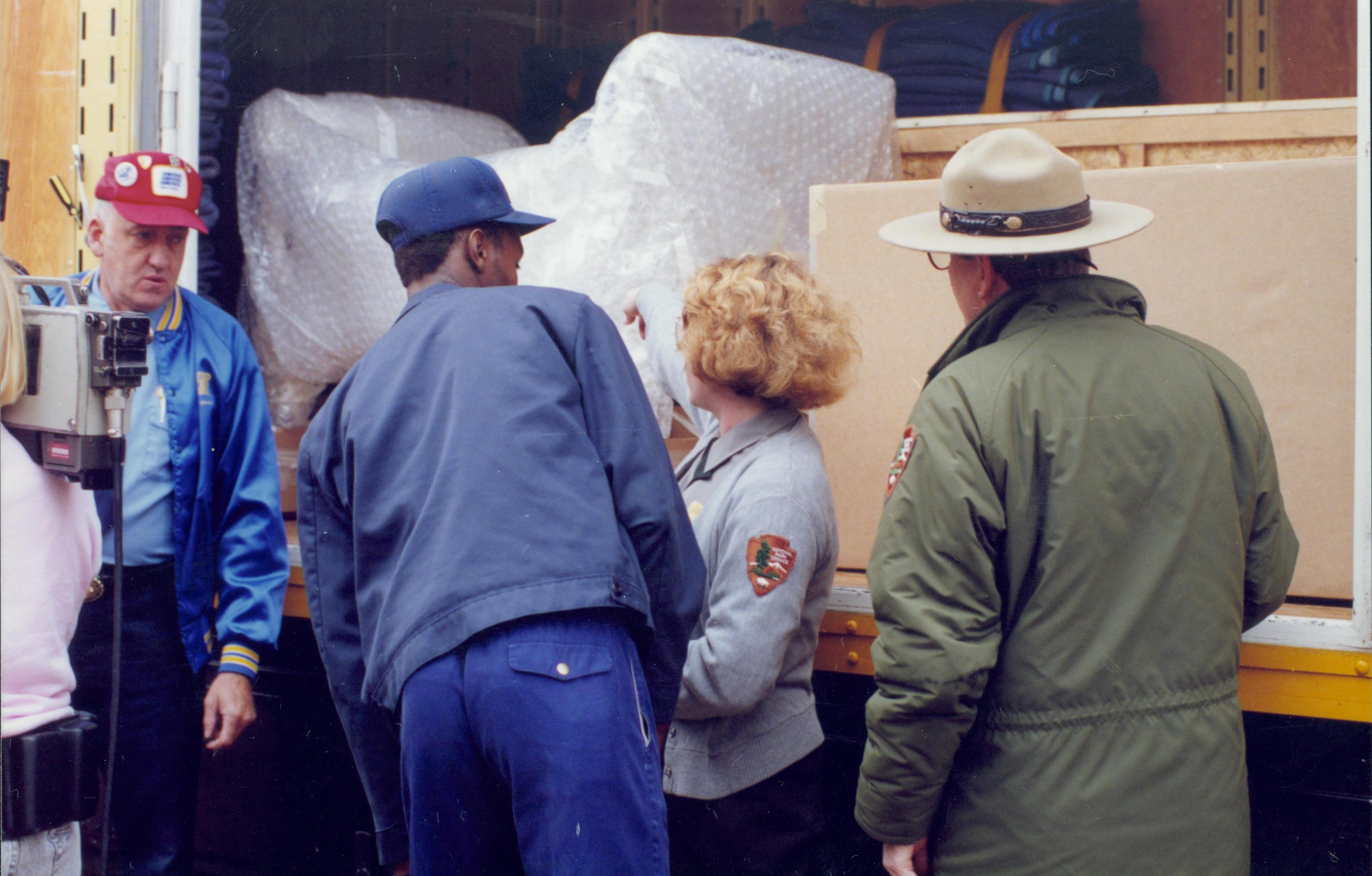 Four people at back of truck. Lincoln Home NHS- Bring Furniture Back Home furniture, unloading