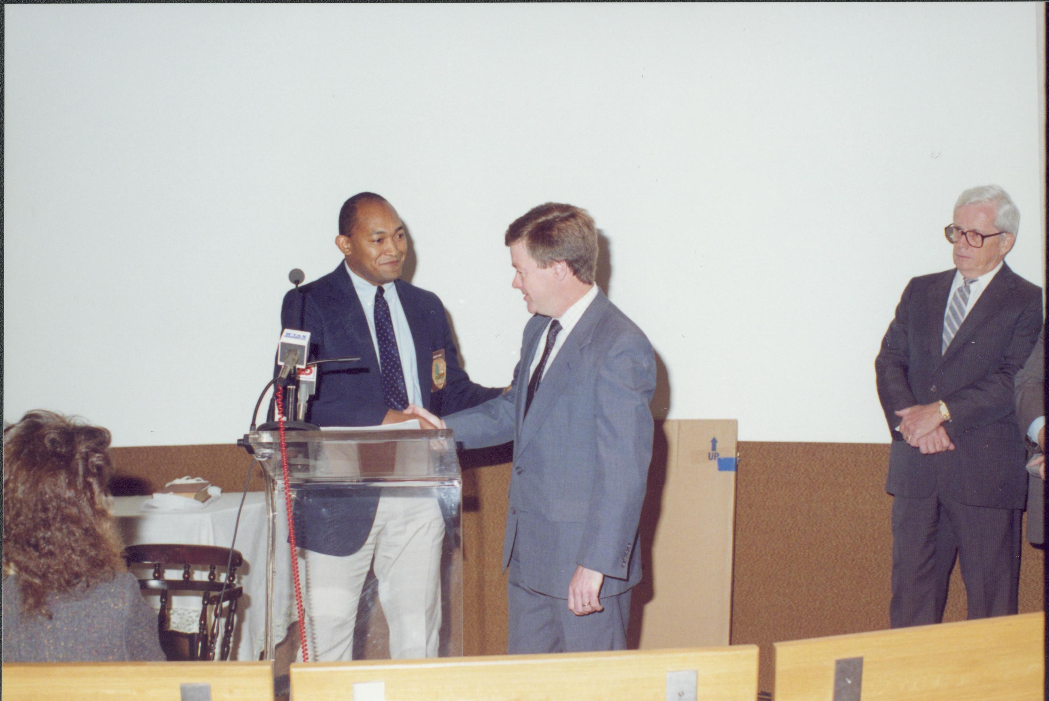 Two men shaking hands at podium. Lincoln Home NHS- Bring Furniture Back Home ceremony, presentation