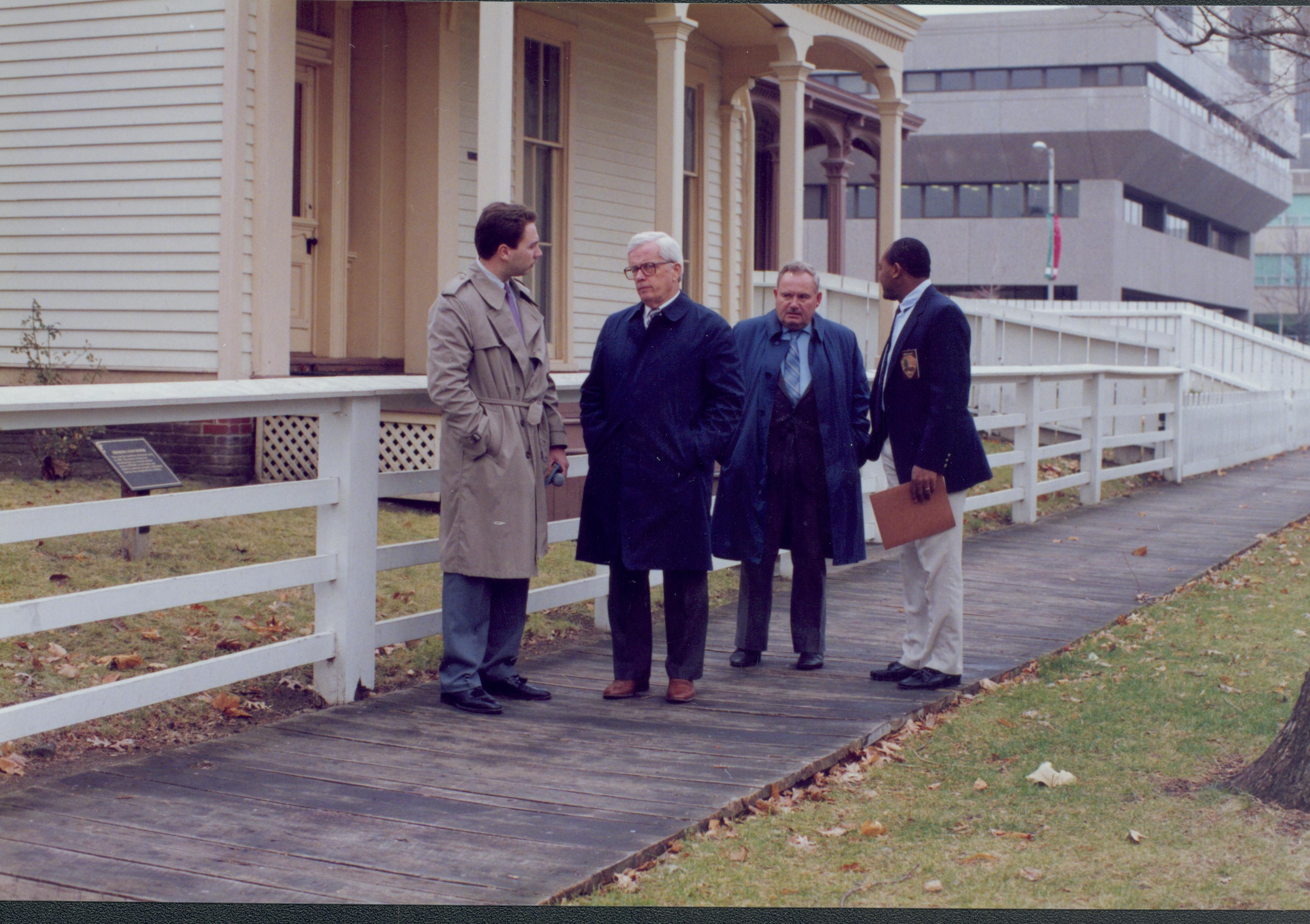 Four men standing in front of fence. Lincoln Home NHS- Bring Furniture Back Home furniture, movers