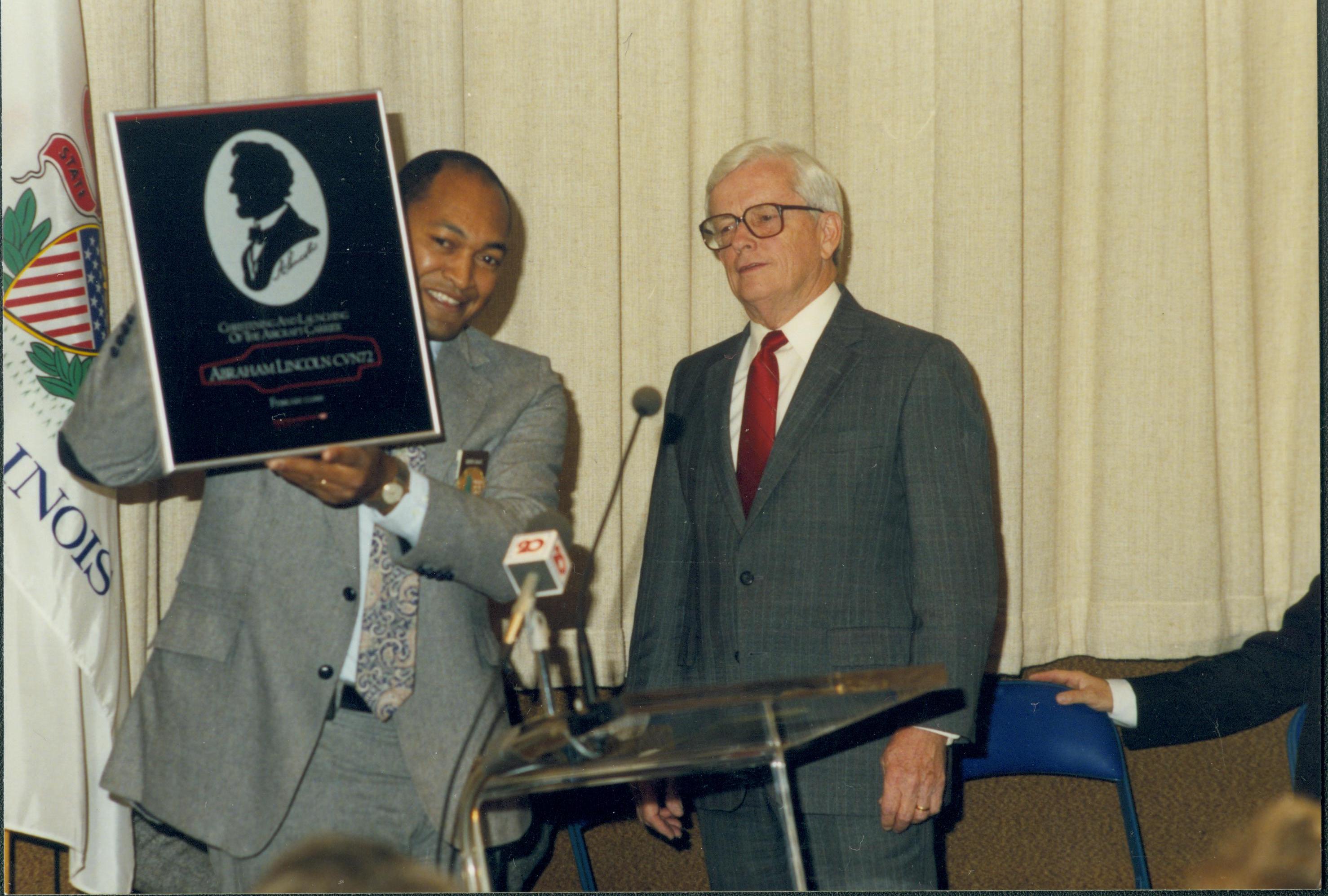 Man holding framed picture of Lincoln silhouette. Lincoln Home NHS- Paul Findley Recognition Award, 3 Finley, award