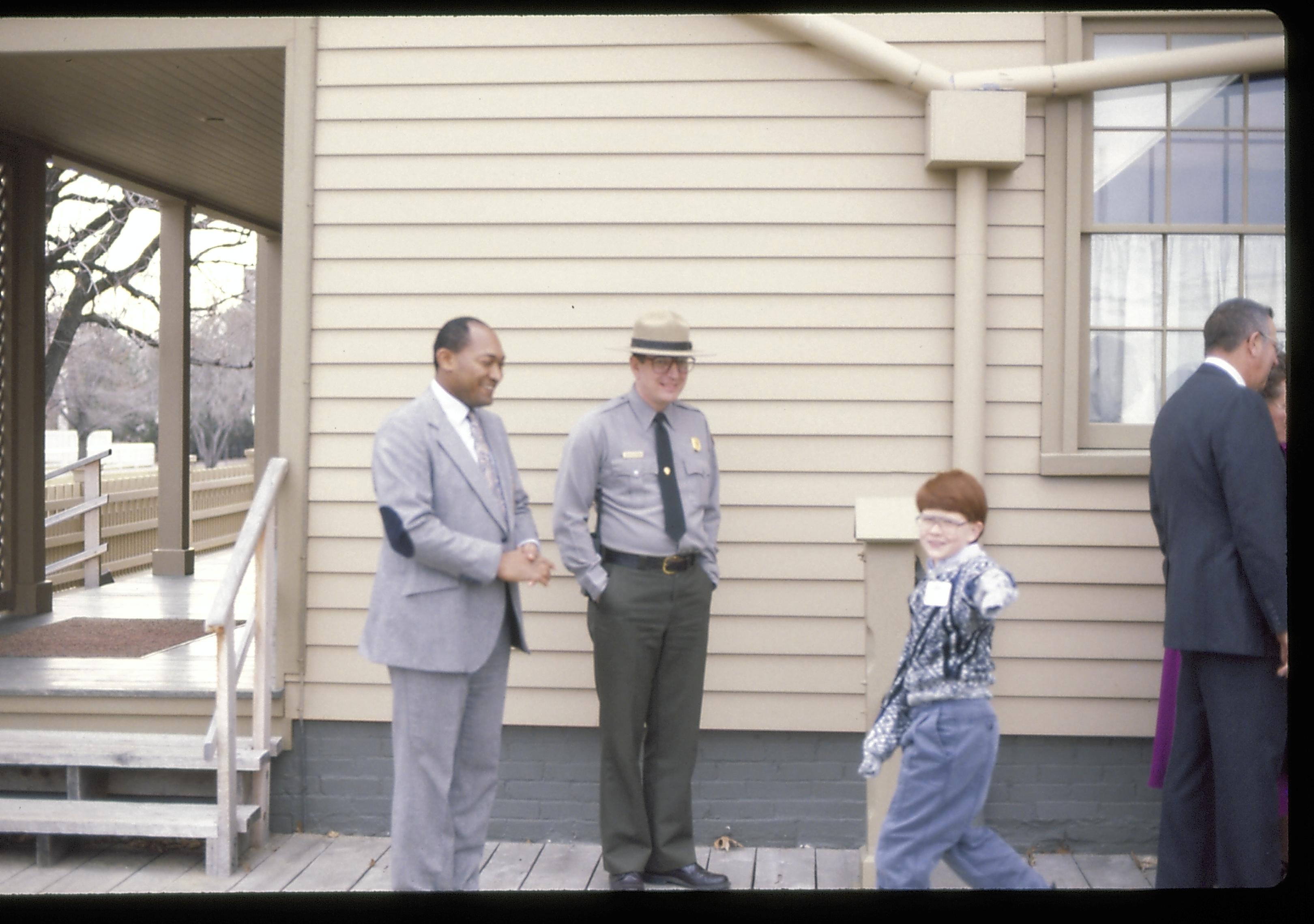 Men standing at rear of home with small boy. Lincoln Home NHS- Paul Findley Recognition Award Finley, award, tour