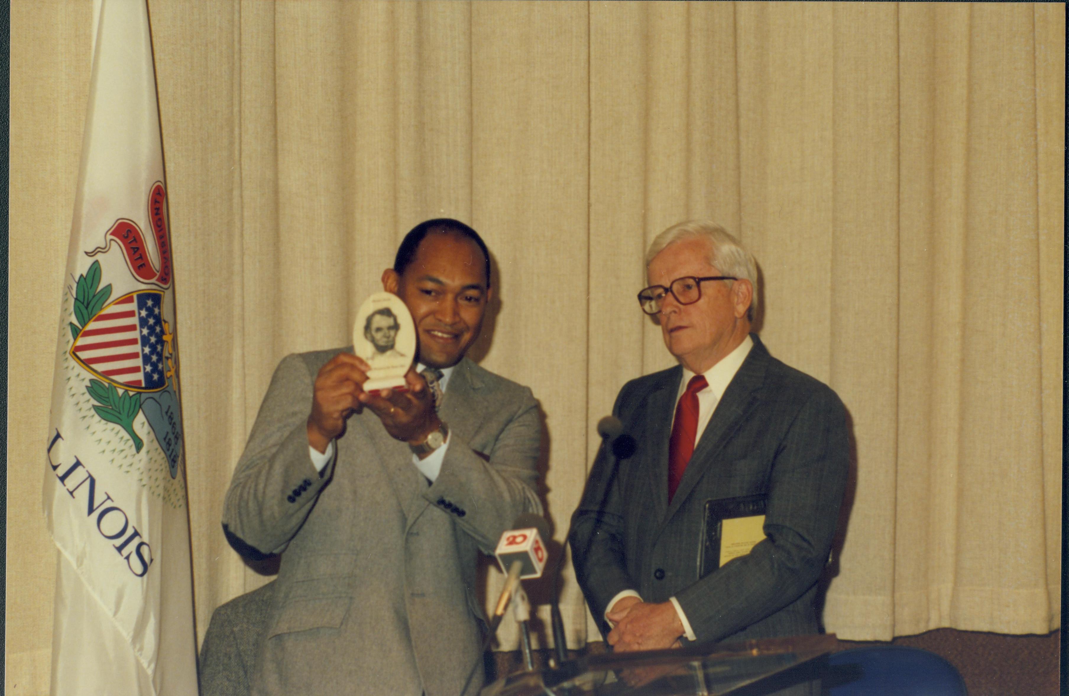 Two men standing at podium. Lincoln Home NHS- Paul Findley Recognition Award, 4314 Finley, award